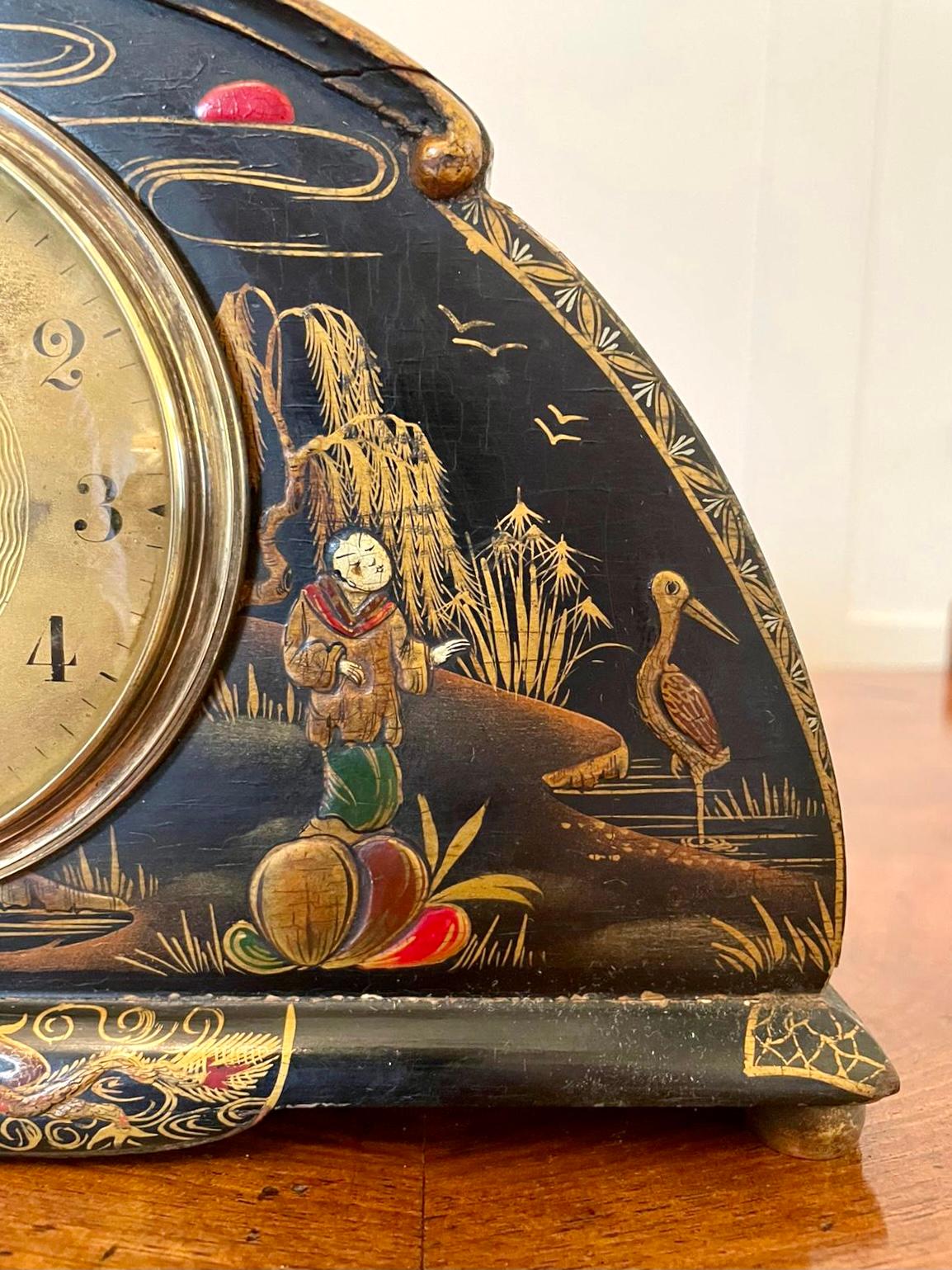 Antique Art Deco lacquered Chinoiserie desk clock having a splendid Art Deco shaped Chinoiserie Lacquered case with Chinese decoration and an eight day movement. It has a brass bezel, brass face and original hands and is in good working
