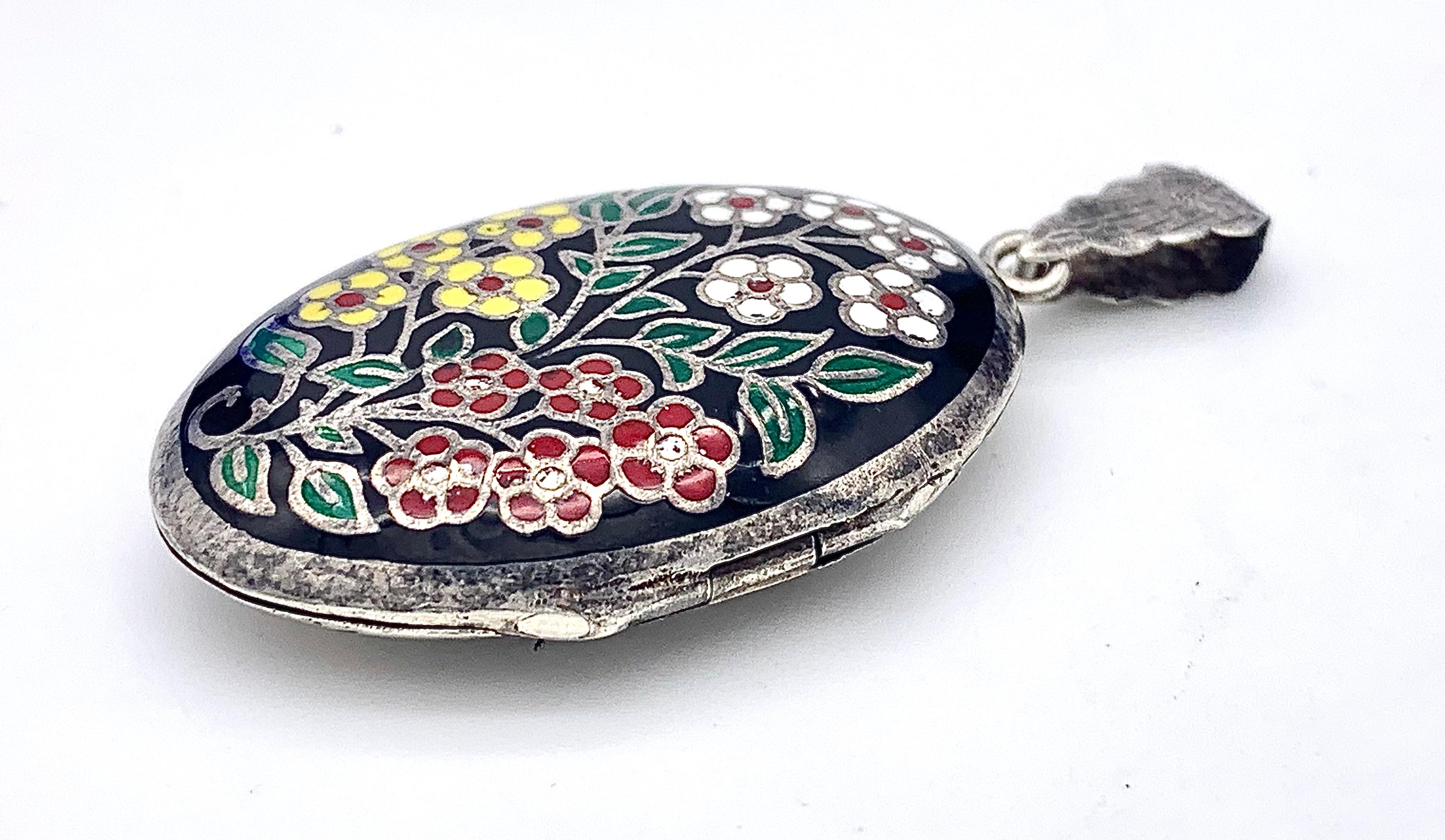 This Art Deco locket is in fine original condition. It came from a family heirloom and has the patina of silver that has not been cleaned for decades. However, it will be cleaned and polished shortly to perfection. 
Before a black background we see