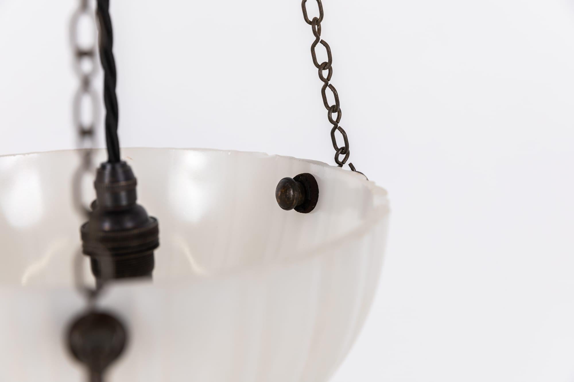 A Diminutive pressed glass 'Moonstone' plafonnier. c.1930

Heavy duty pressed milk glass of fluted design, supported by integral hooks and ceiling plate. Chains could be shortened to suit drop.

Rewired with black twisted flex.