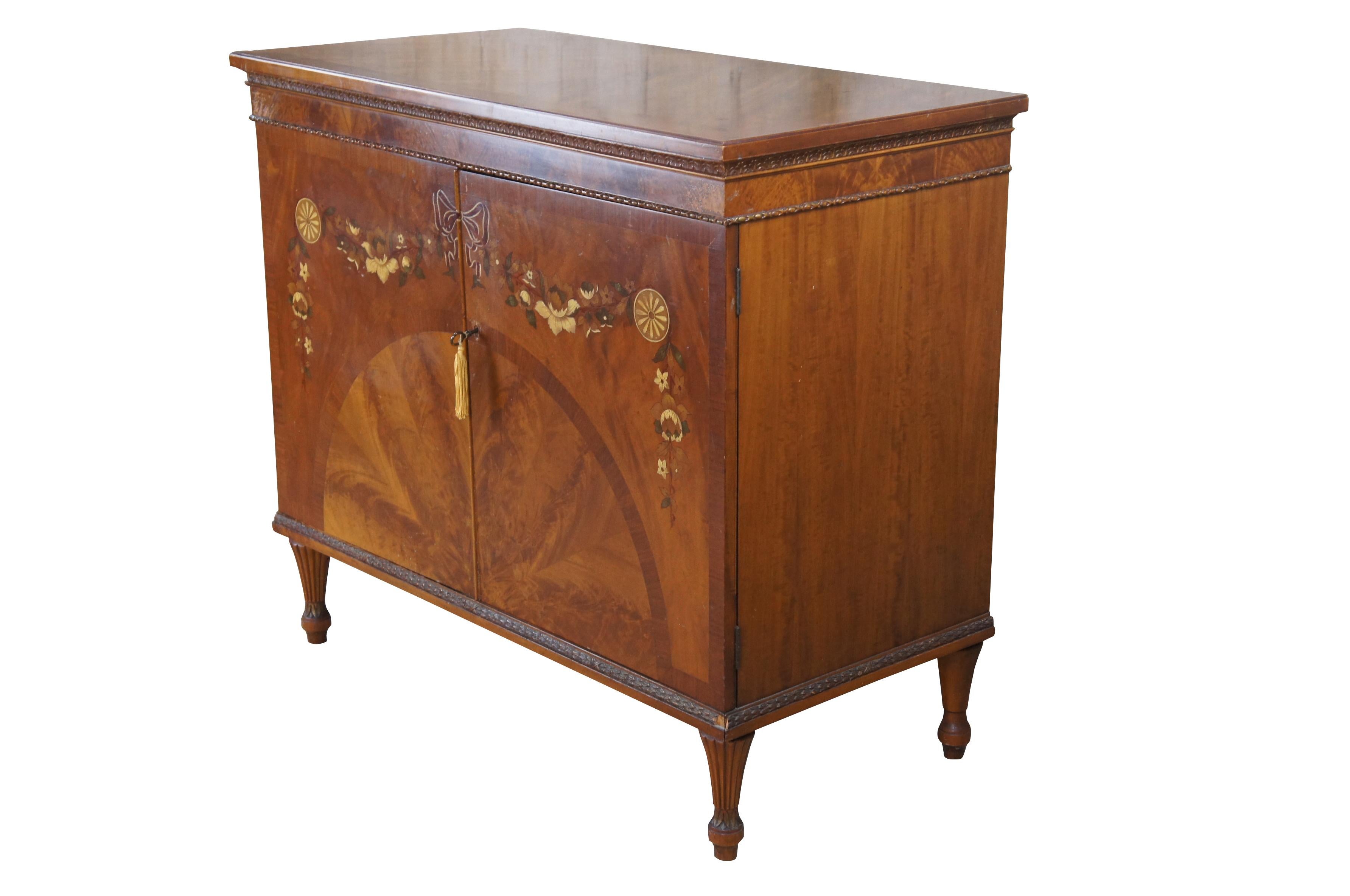 Antique satinwood buffet / cabinet / sideboard / console / Credenza / Huntboard featuring Italian Neoclassical and Art Deco styling with inlaid sunburst / starburst veneer surrounded by hand painted  floral wreath with ribbons, bows and pinwheels. 