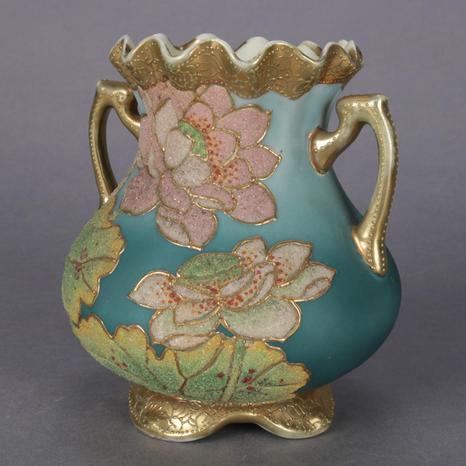 An antique Japanese Art Deco Nippon Coraline decorated vase features double handled bulbous form with ruffled rim and scroll form feet, all-over moriage decorated with flowers and heavy gilt banding, marked on base, circa 1920.

Measures: 5.5