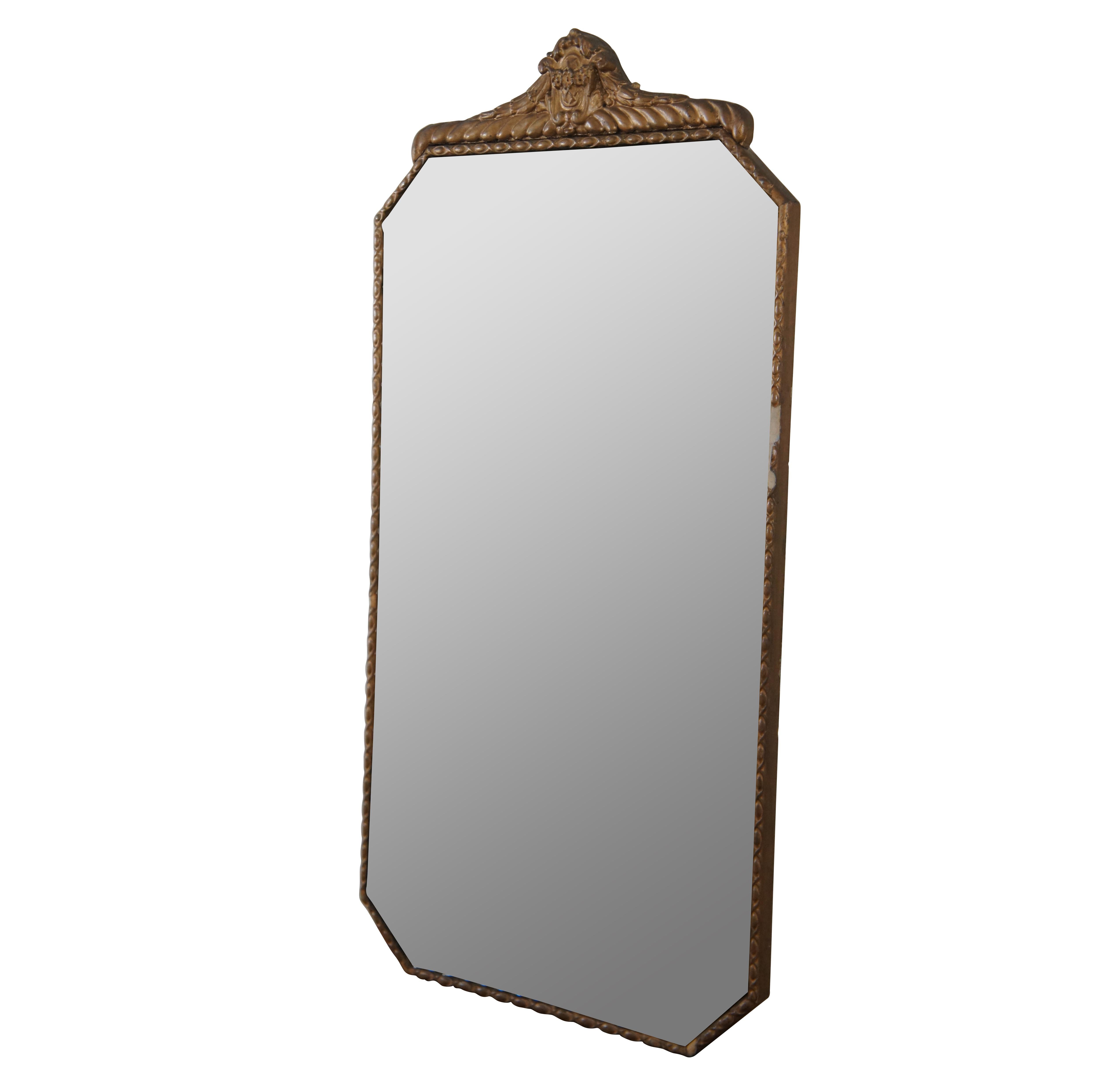 Antique early 20th century art deco wall mirror by the H. Neuer Glass Company of Cincinnati, Ohio – features a rectangular form with octagonal cut corners and a scalloped pattern along the edge of the glass, etched with a cascading leafing vine,