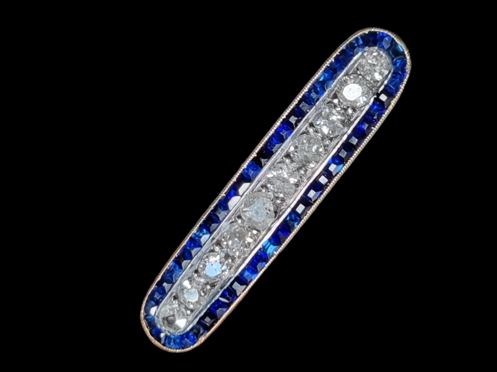 Antique Art Deco Old Cut Diamond and  Blue Sapphire Bar Brooch (Ca. 1915-1920)
Hand fabricated in 18Karat Gold (tested). Original Art Deco bar pin, this striking geometric jewel oval shaped, measuring 3.45 cm (USA 1 1/3 inches). Centering ten old