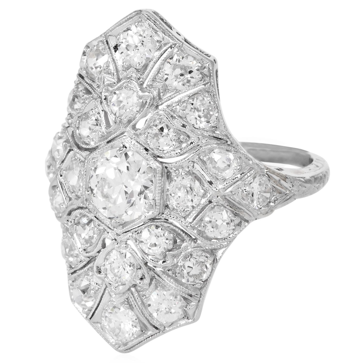 ntique 1920s Platinum navette cluster ring features a dazzling array of round cut natural diamonds. At its heart lies a 0.40 carat center stone, framed by additional Old European-cut diamonds. The intricate openwork and symmetrical geometry are