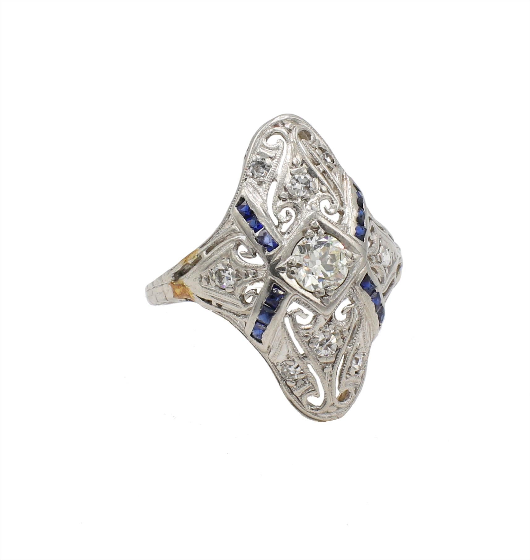 Antique Art Deco Old European Cut Diamond & Sapphire Filigree Navette Ring Size 5
Metal: Platinum
Weight: 3.25 grams
Diamonds: Approx. .30 CTW H-I VS
Sapphires: 12 french cut blue sapphires, approx. .18 CTW, facet junctions are slightly abraded from