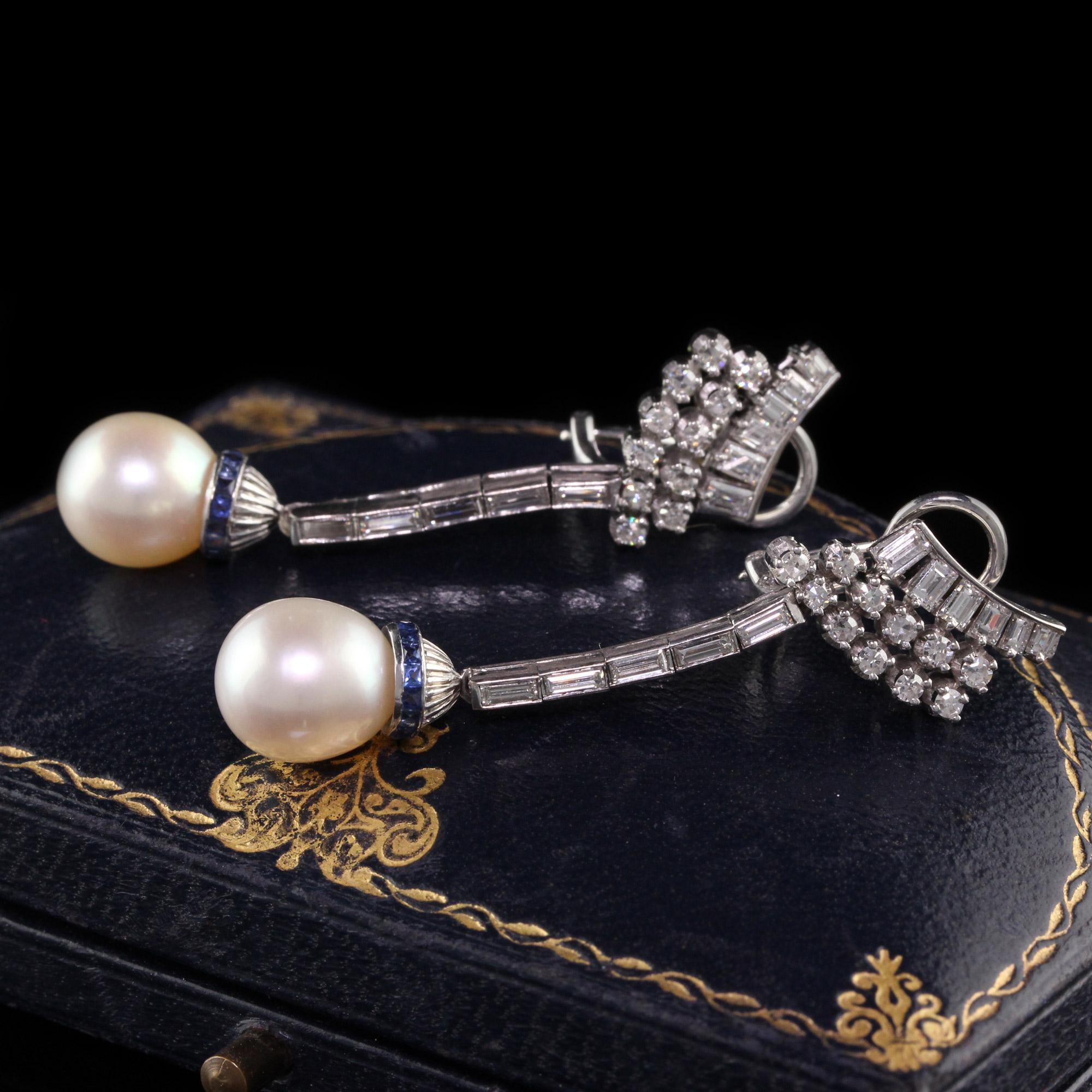Gorgeous Antique Art Deco Palladium Diamond Sapphire Pearl Drop Earrings. These beautiful pair of earrings have single cut and baguettes on the earrings with french cut sapphires around the pearl drop.

Item #E0029

Metal: Palladium

Diamonds: