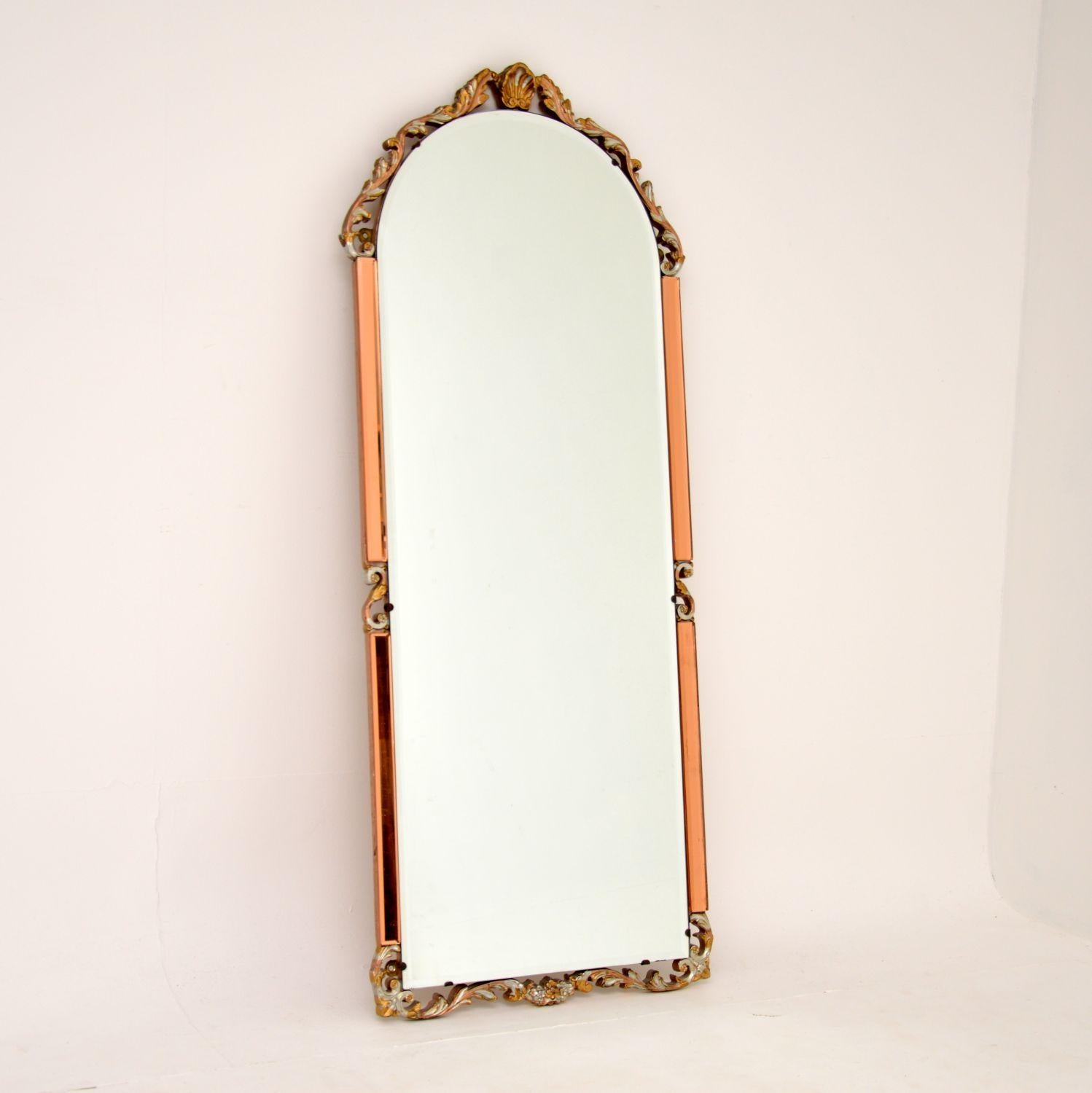 A beautiful and interesting antique mirror made from clear and peach beveled glass. This was made in England, it dates from around the 1930’s period.

It is from the Art Deco period and is an interesting mix of styles. The peach and clear glass