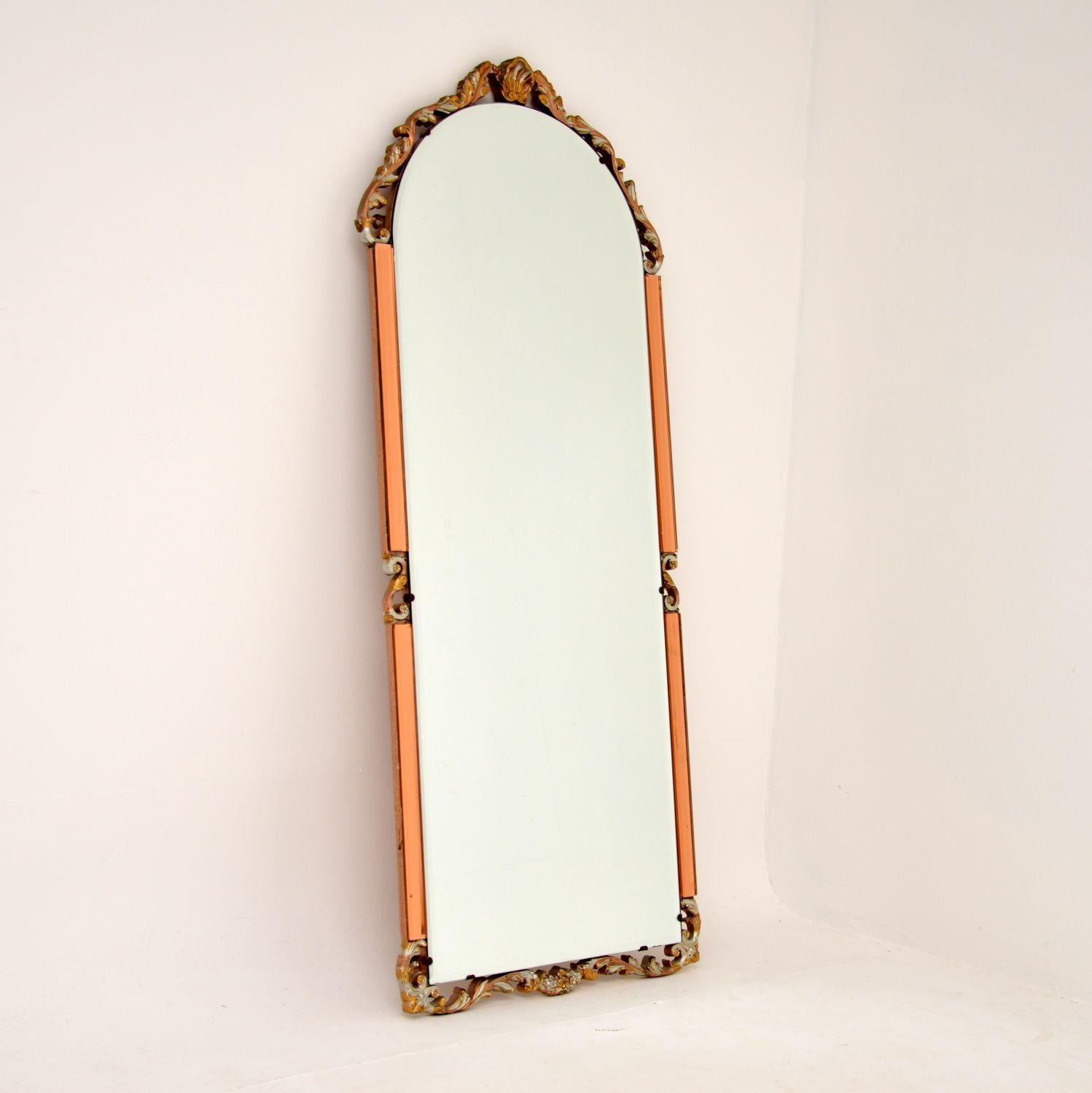A beautiful and interesting antique Art Deco period decorative mirror made from clear and peach beveled glass. This was made in England, it dates from around the 1930’s period.

It is from the Art Deco period and is an interesting mix of styles. The