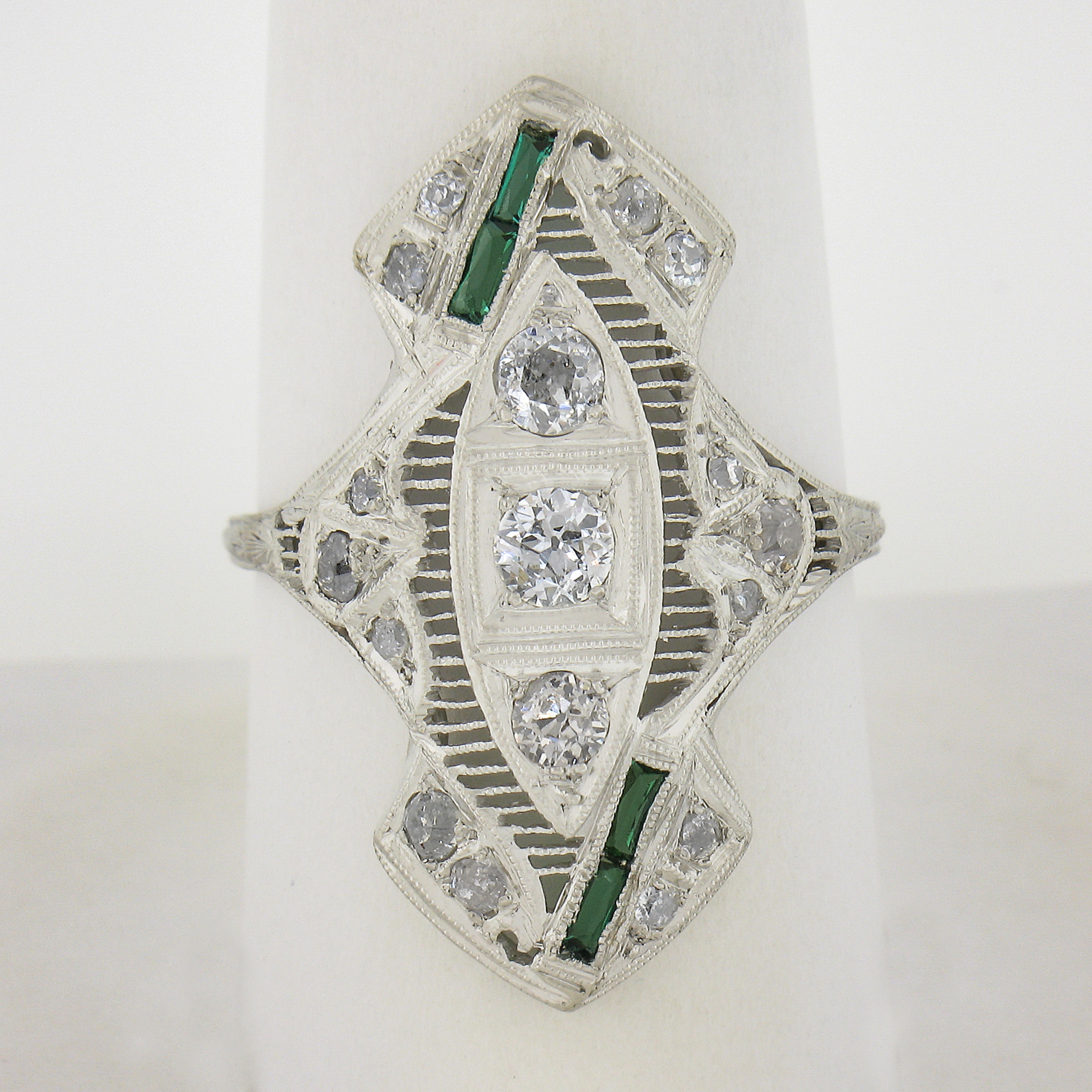 This incredible, antique art deco period ring is crafted in solid platinum. The ring showcases 17 old European & single cut diamonds elegantly pave set throughout the long and unusual design in which is further further accented with 4 rectangular