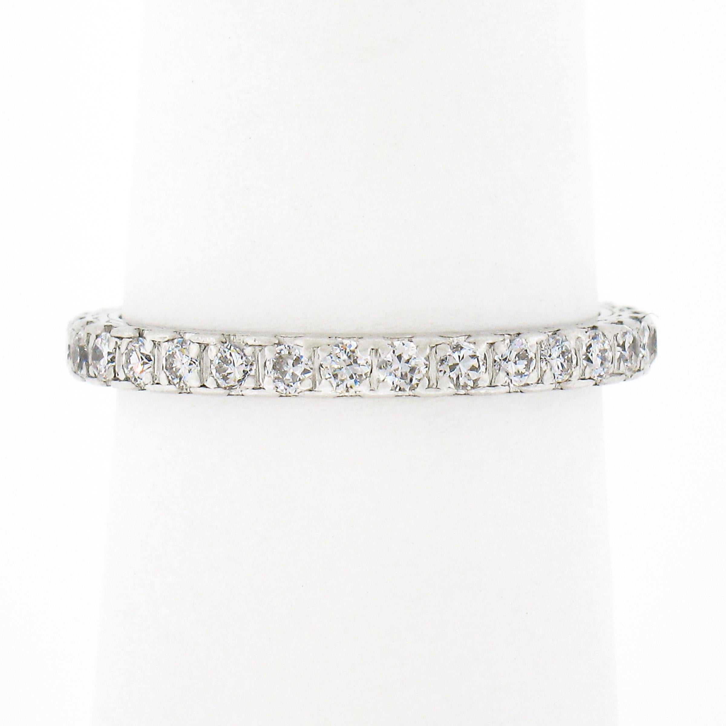 This gorgeous antique diamond eternity band ring was crafted from solid .900 platinum during the 1930's. It features a simple design that carries VERY fine and fiery old transitional cut diamonds that are neatly pave set all the way around the band.
