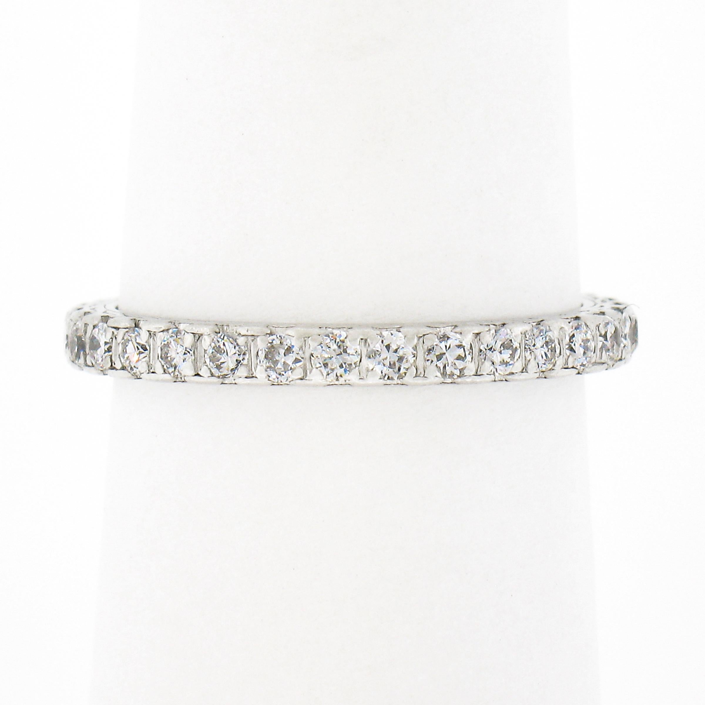 This gorgeous antique diamond eternity band ring was crafted from solid .900 platinum during the 1930's. It features a simple design that carries VERY fine and fiery old transitional cut diamonds that are neatly pave set all the way around the band.