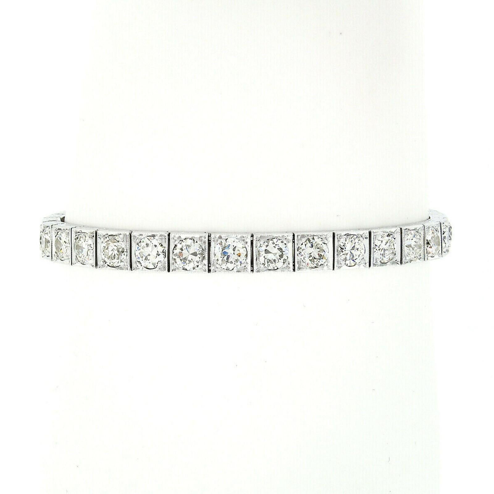 This absolutely breathtaking antique diamond statement tennis bracelet was crafted in solid .900 platinum during the late Art Deco period and is covered with fine quality and LARGE diamonds, amazing milgrain work, and detailed engraving designs on