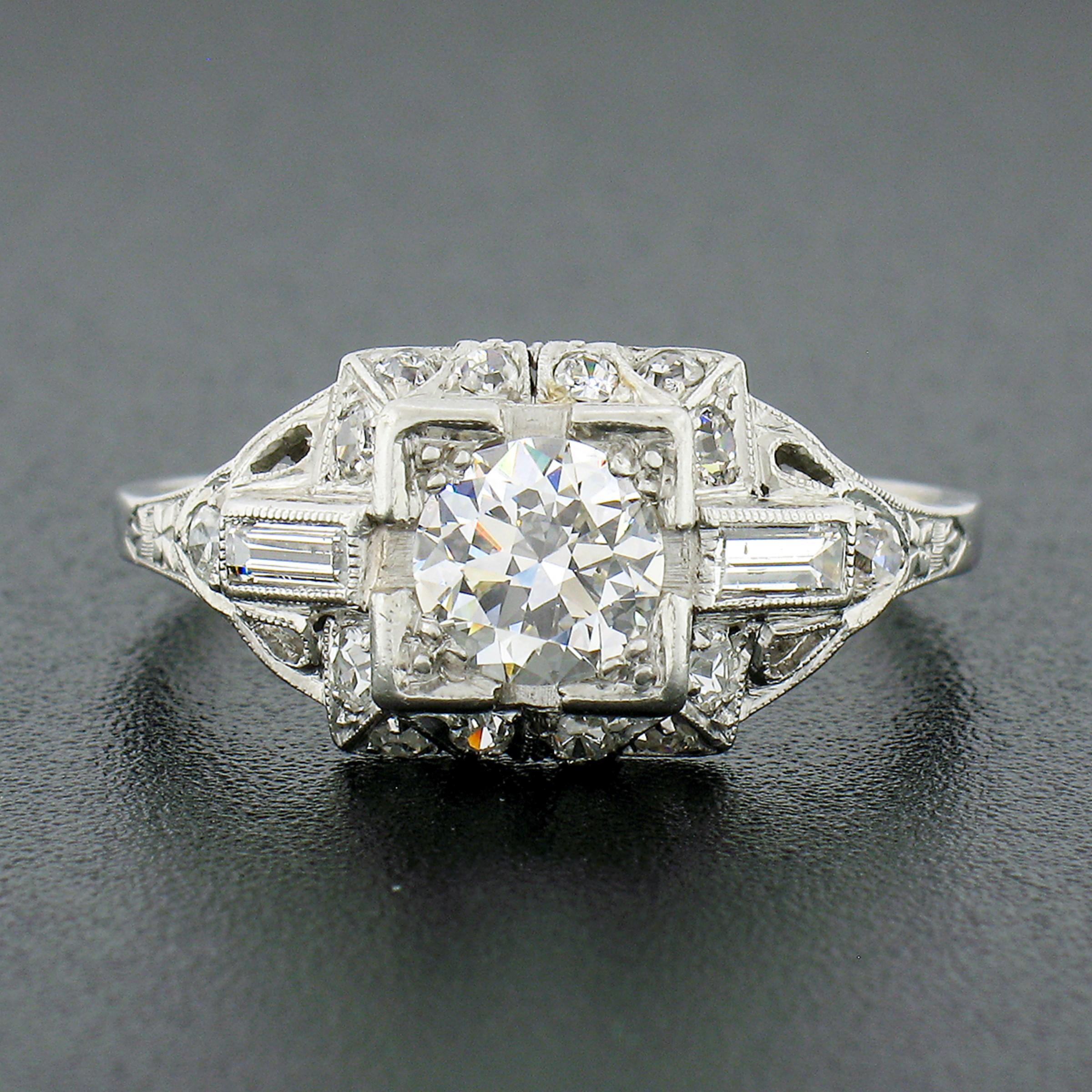This breathtaking antique diamond engagement ring was crafted from solid platinum during the art deco period and features a stunning, old European cut, diamond solitaire at its center. The fine diamond solitaire shows a nice large size and
