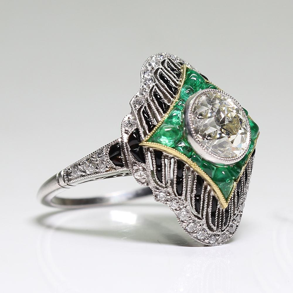 Period: Art Deco (1920-1935)
Composition: Platinum
Stones:
•	1 Old mine cut diamond of J/K-VS1 quality that weighs 1.66ctw. 
•	40 Old mine cut diamonds of H-VS2 quality that weigh 0.50ctw.
•	15 natural Colombian calibrated cut emeralds that weigh