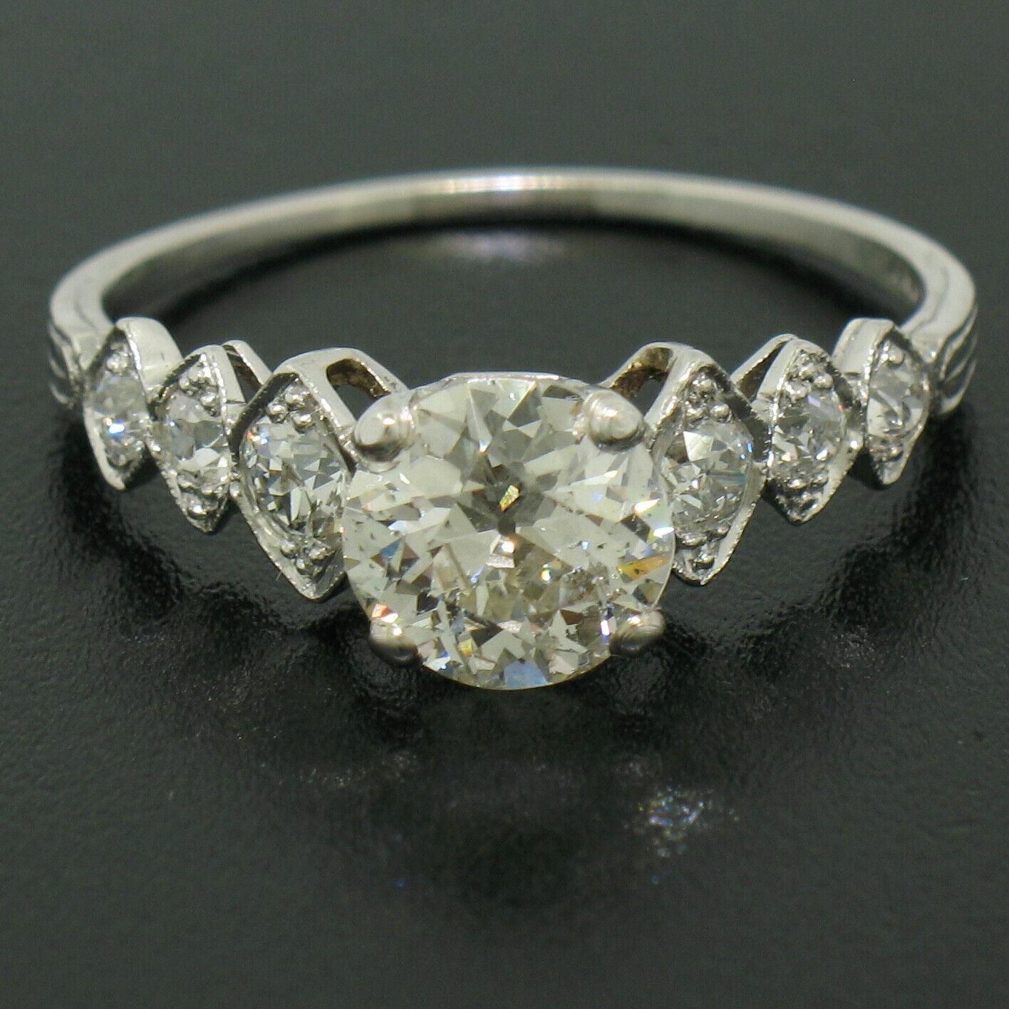Here we have an ALL ORIGINAL antique ring crafted from solid 900 platinum during the art deco period. The ring features a fabulous center diamond weighing approximately 1.35 carats. The stone is perfectly old European cut and, as such, is very
