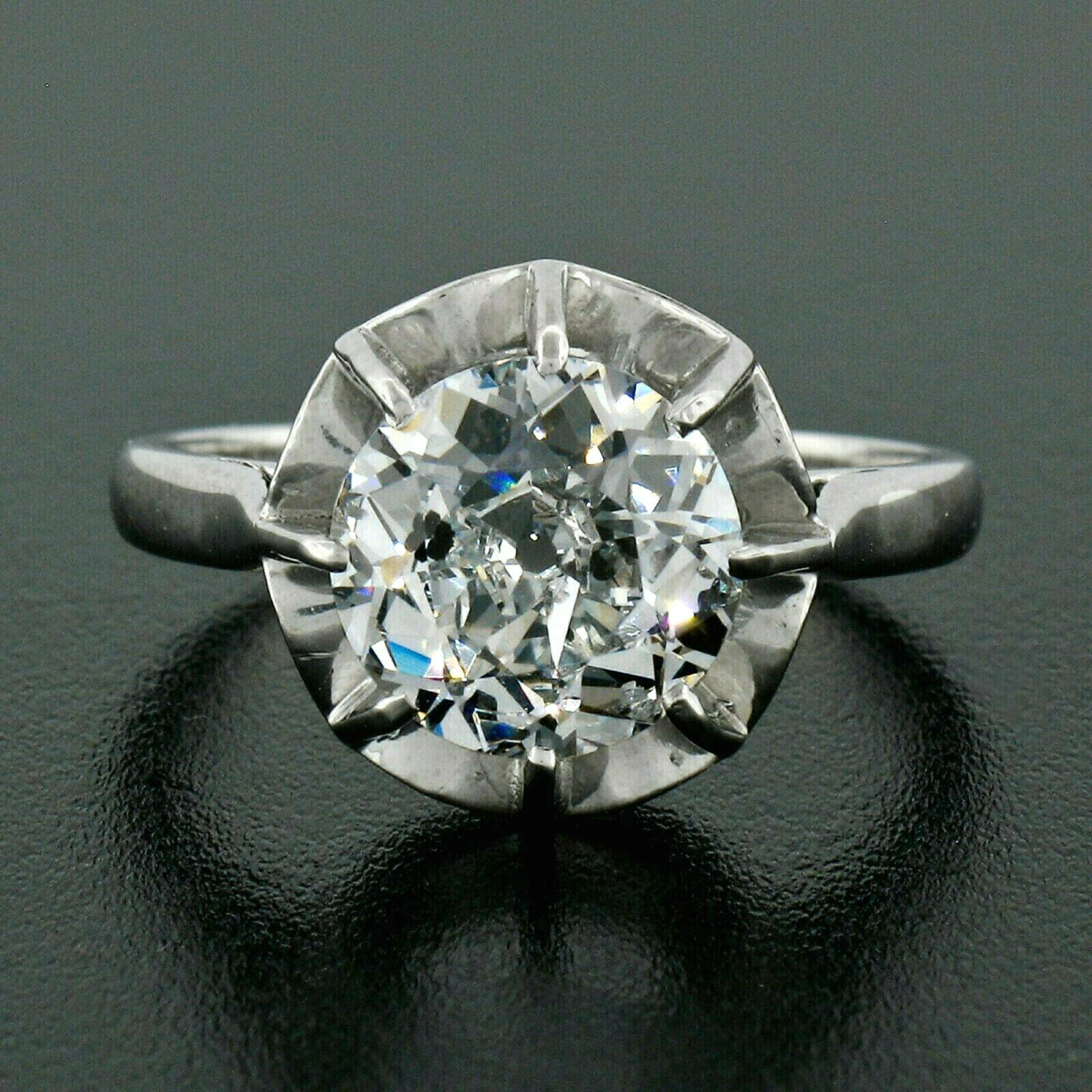 This gorgeous antique diamond engagement ring was hand crafted in solid .900 platinum during the art deco period and features a very simple and elegant design set with a stunning, old European cut diamond prong set at its center. The center stone