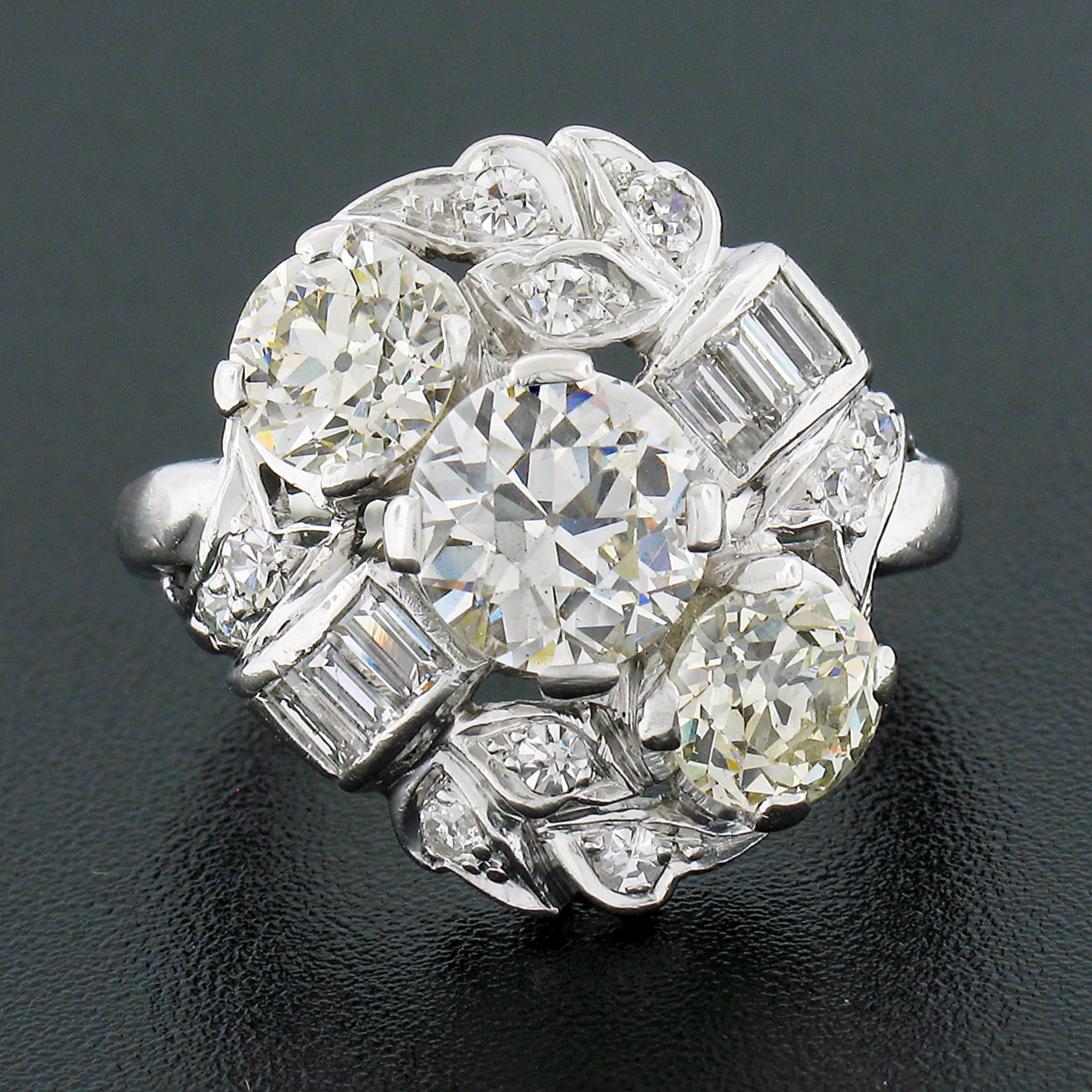 Here we have an absolutely magnificent, antique, diamond engagement or cocktail ring that was crafted from solid platinum during the art deco period. It features 3 old European cut diamonds, with each showing a nice large size, that are diagonally
