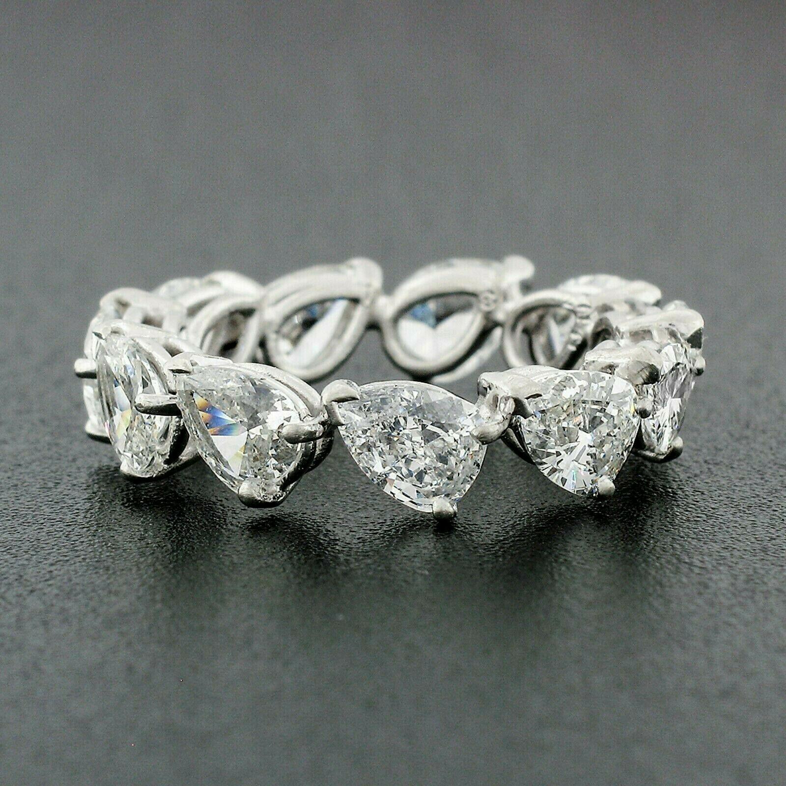 This stunning antique diamond band was crafted from solid .900 platinum during the late art deco period. It features a classic eternity style made from 11 old pear cut diamonds that give it a truly unique look. These diamonds are rather large,