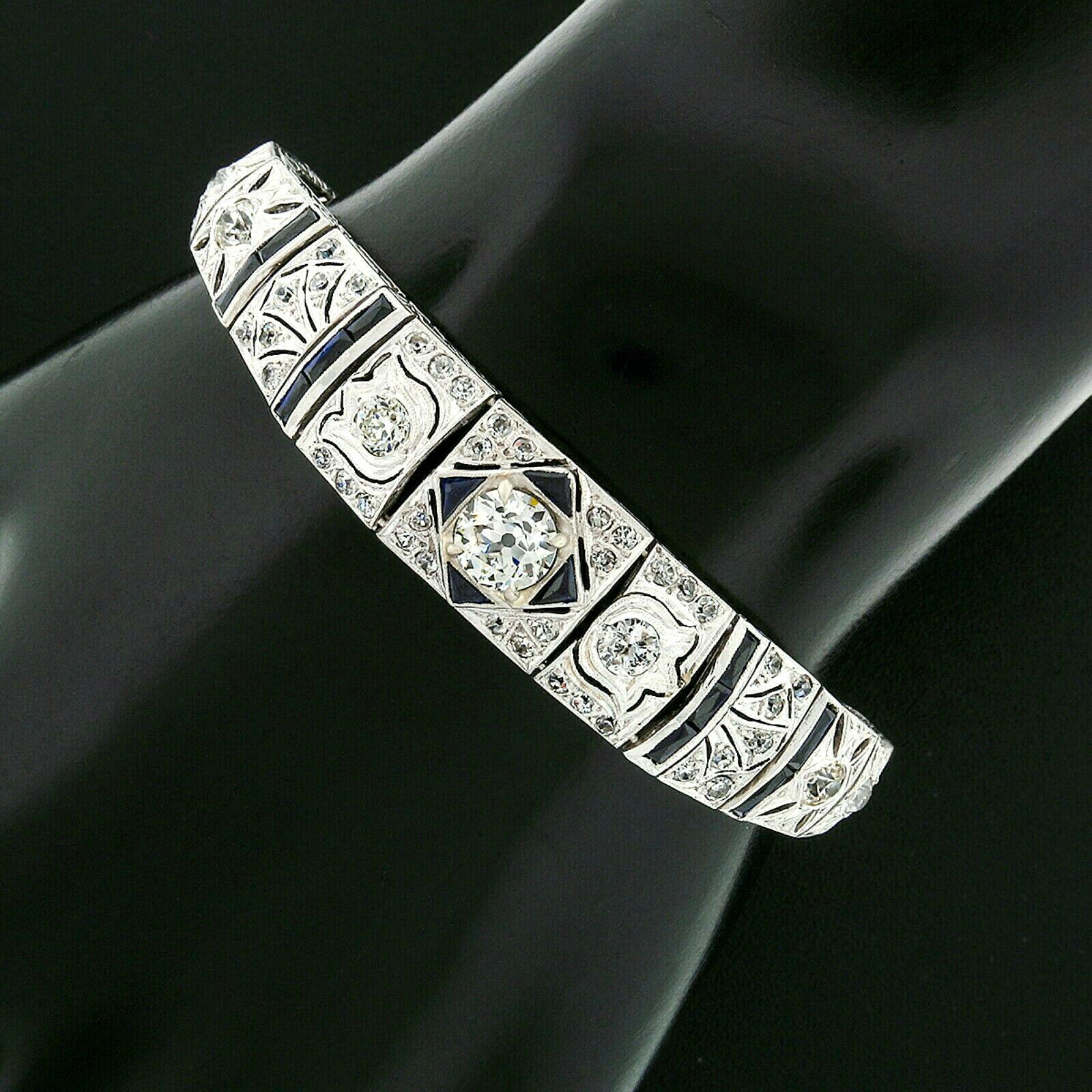 This gorgeous antique filigree bracelet was crafted from solid 900 platinum during the art deco period. It features a beautiful, GIA certified, old European cut diamond prong set at its center. This center diamond is exceptionally brilliant and