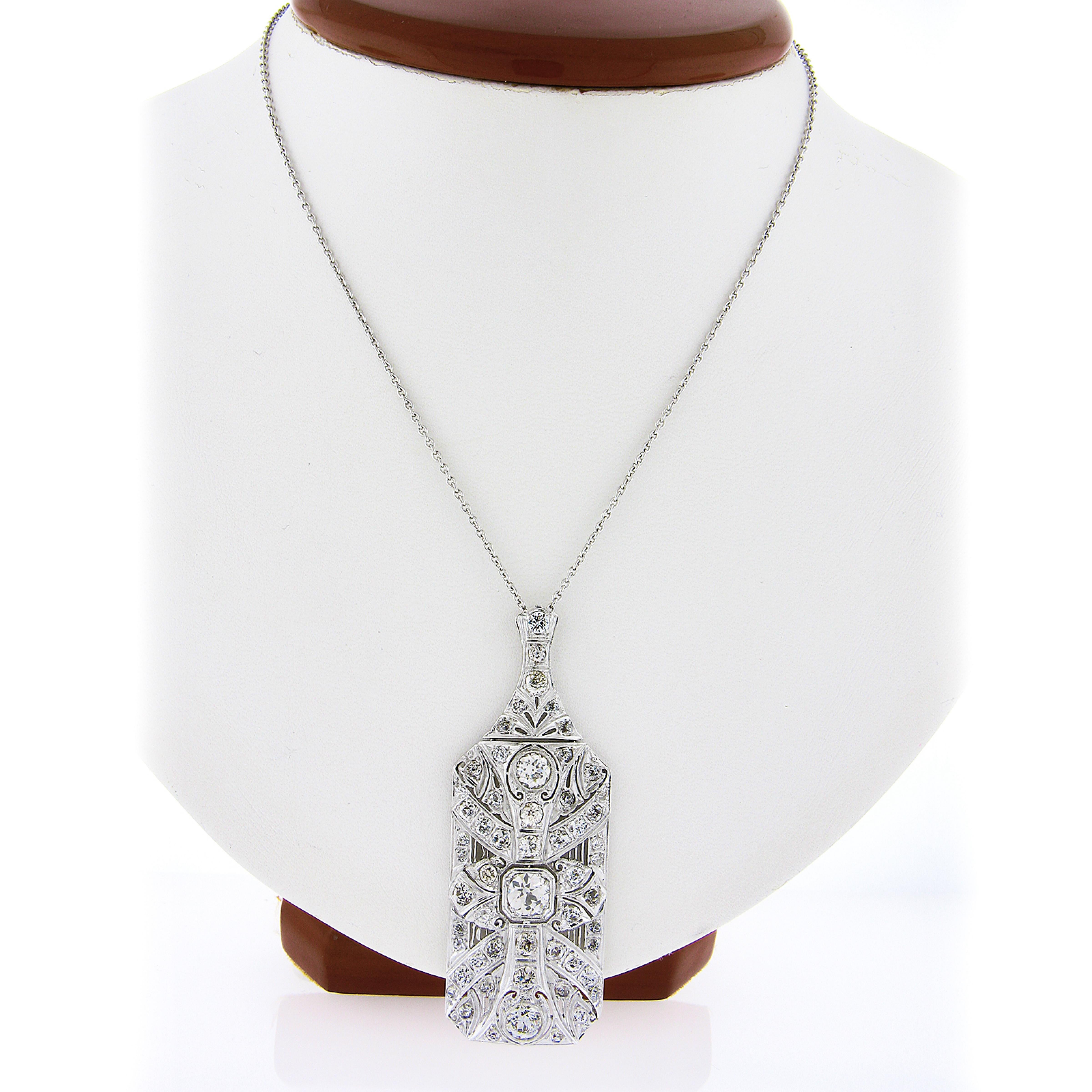 Here we have an absolutely breathtaking antique diamond statement pendant crafted in solid platinum during the art deco period. This elegant and large piece is completely drenched with very fine quality old European cut diamonds throughout that