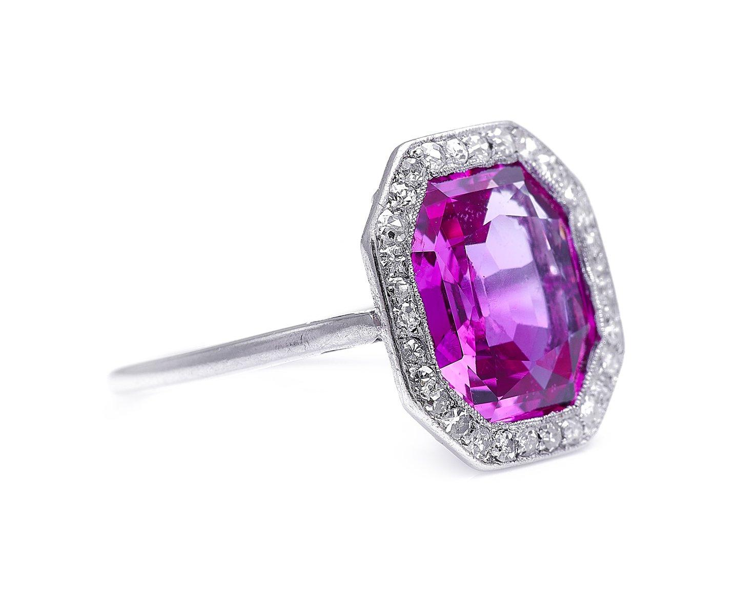 Pink sapphire and diamond ring, 1920s. The pink sapphire at the centre of this ring is blessed with both an unusual and attractive early 20th century geometric cut, and a beautiful magenta body colour. Pink sapphires, like rubies, are coloured by
