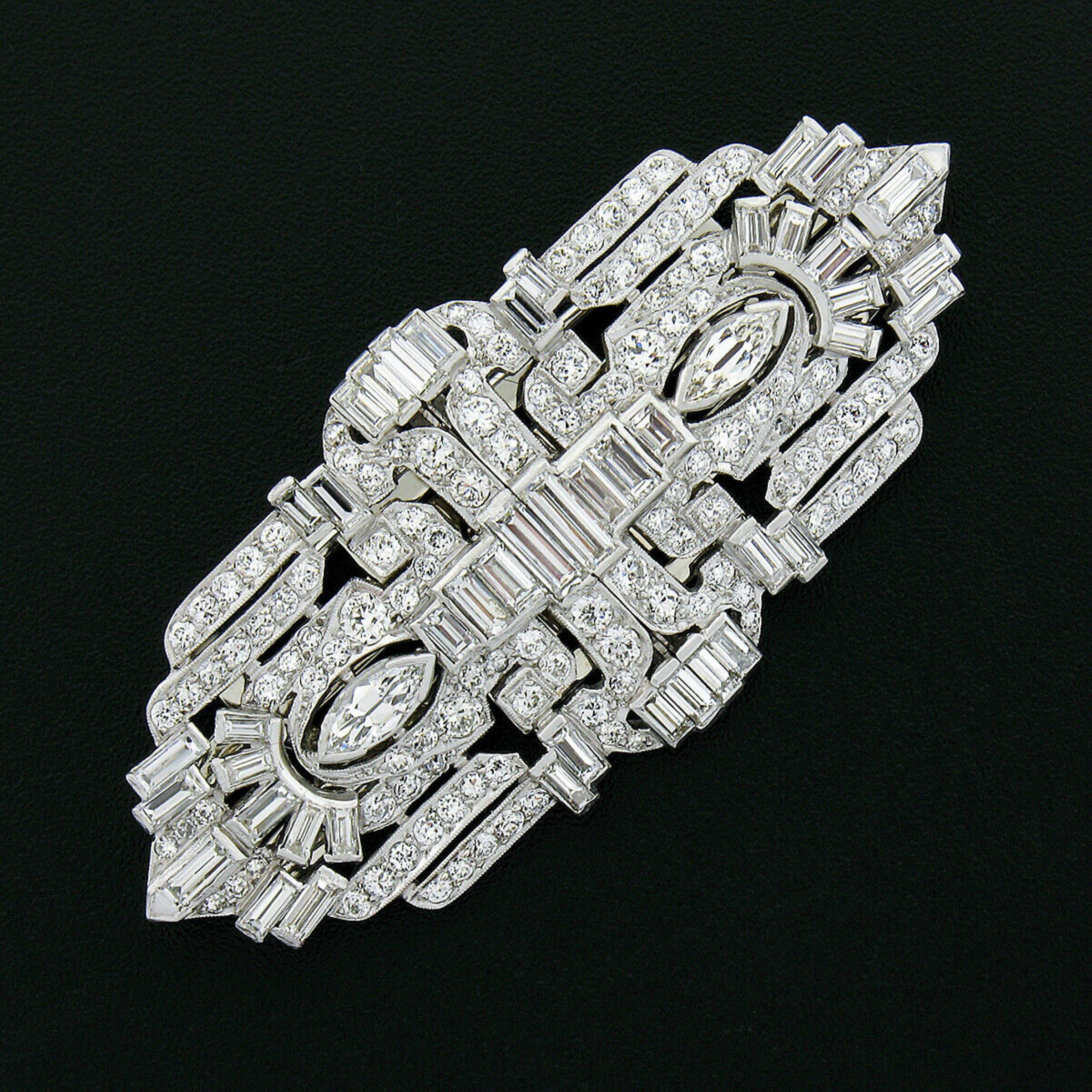 Here we have a gorgeous and very lovely pair of antique diamond dress clips that were crafted from solid .900 platinum during the art deco period. Each clip is v-prong set with an old marquise cut diamond weighing approximately 0.30 carats, channel