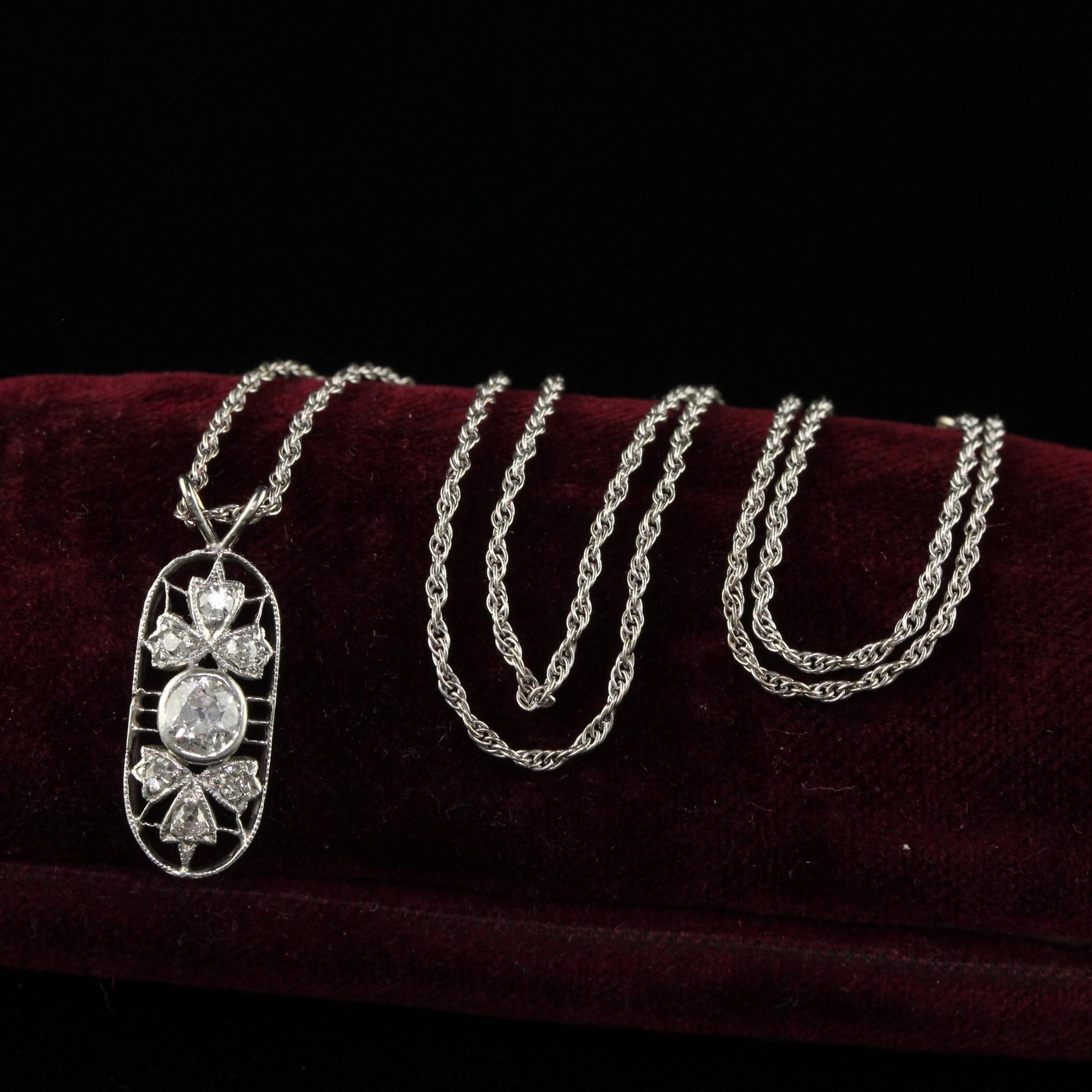 Beautiful Antique Art Deco Platinum and White Gold Old Mine Diamond Filigree Pendant. This gorgeous Art Deco pendant is crafted in platinum and the chain is 14k white gold. The pendant features old mine cut diamonds with a beautiful floral filigree