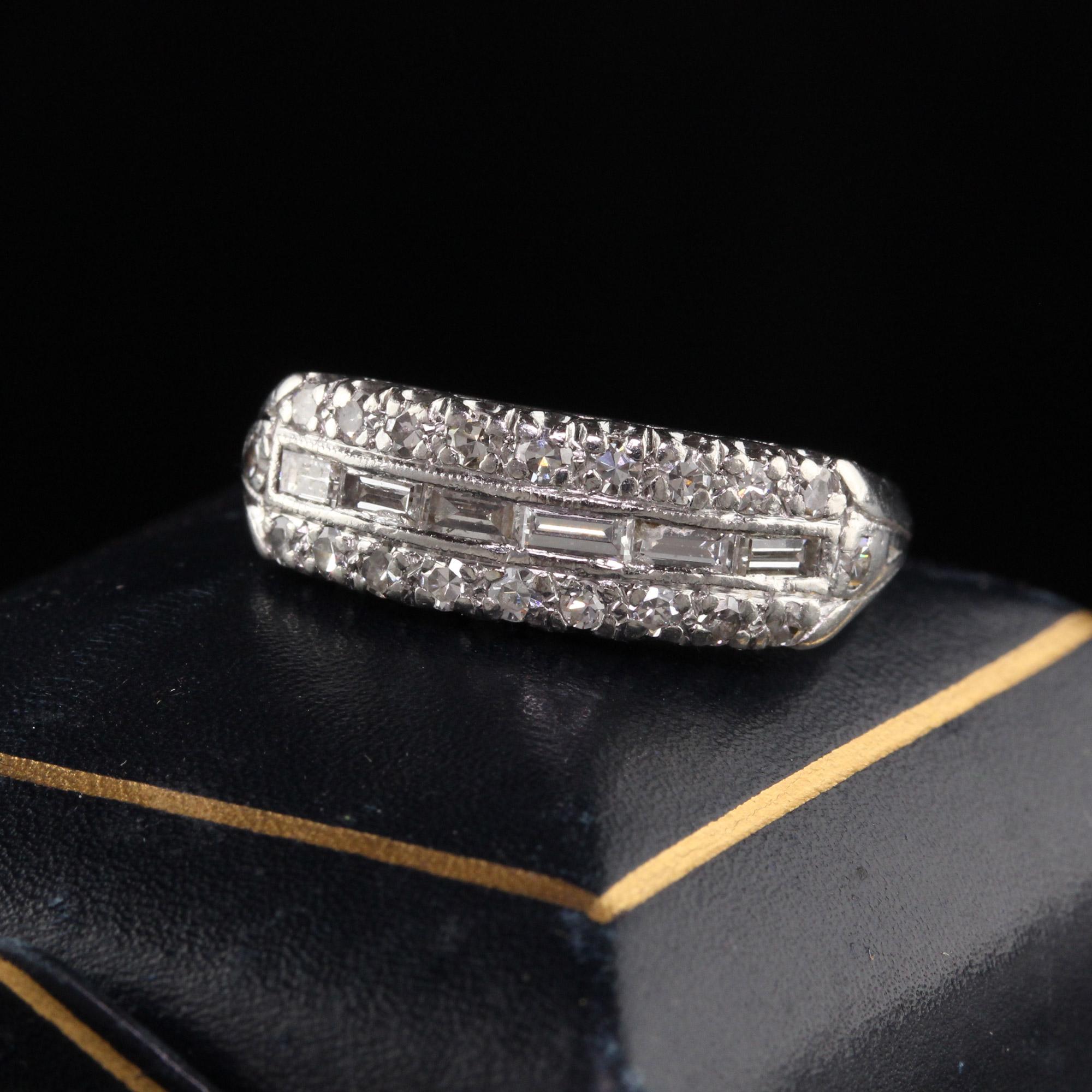 Beautiful Antique Art Deco Platinum Baguette and Single Cut Diamond Wedding Band. This beautiful wedding band is crafted in platinum and has a row of baguette diamonds in the center of two rows of single cut diamonds. One of the baguette diamonds is