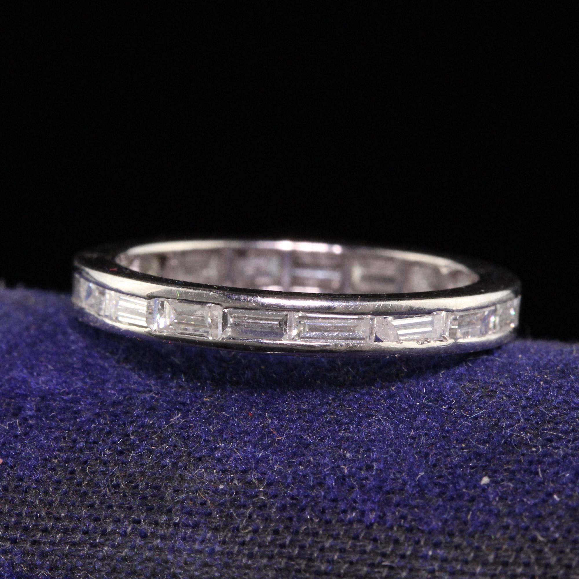 Beautiful Antique Art Deco Platinum Baguette Diamond Eternity Band - Size 5. This classic eternity band is crafted in platinum. There are beautiful white baguette diamonds going around the entire ring. One of the diamonds has a chip on the corner