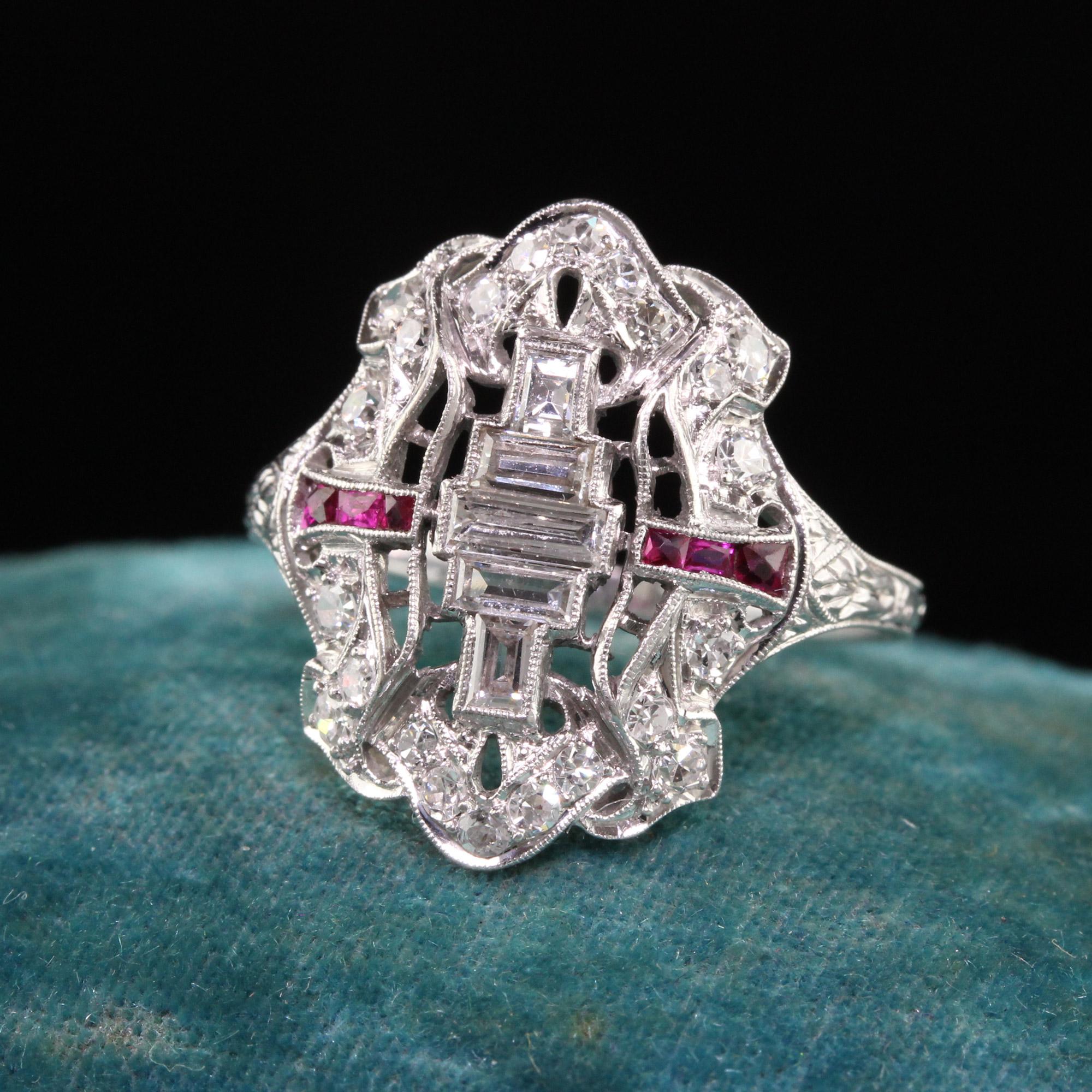 Beautiful Antique Art Deco Platinum Baguette Old Euro Diamond and Ruby Shield Ring. This incredible ring is crafted in platinum. The ring has old cut baguettes in the center and old cut diamonds on top of the ring. There are also french cut natural
