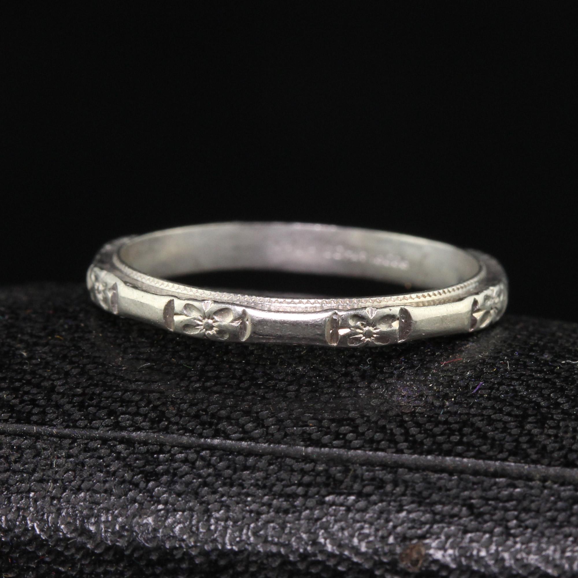 Beautiful Antique Art Deco Platinum Blossom Design Engraved Wedding Band - Size 5 1/2. This beautiful wedding band is crafted in platinum. The ring has crisp blossom engravings going around the entire ring and has milgraining on the sides as well.