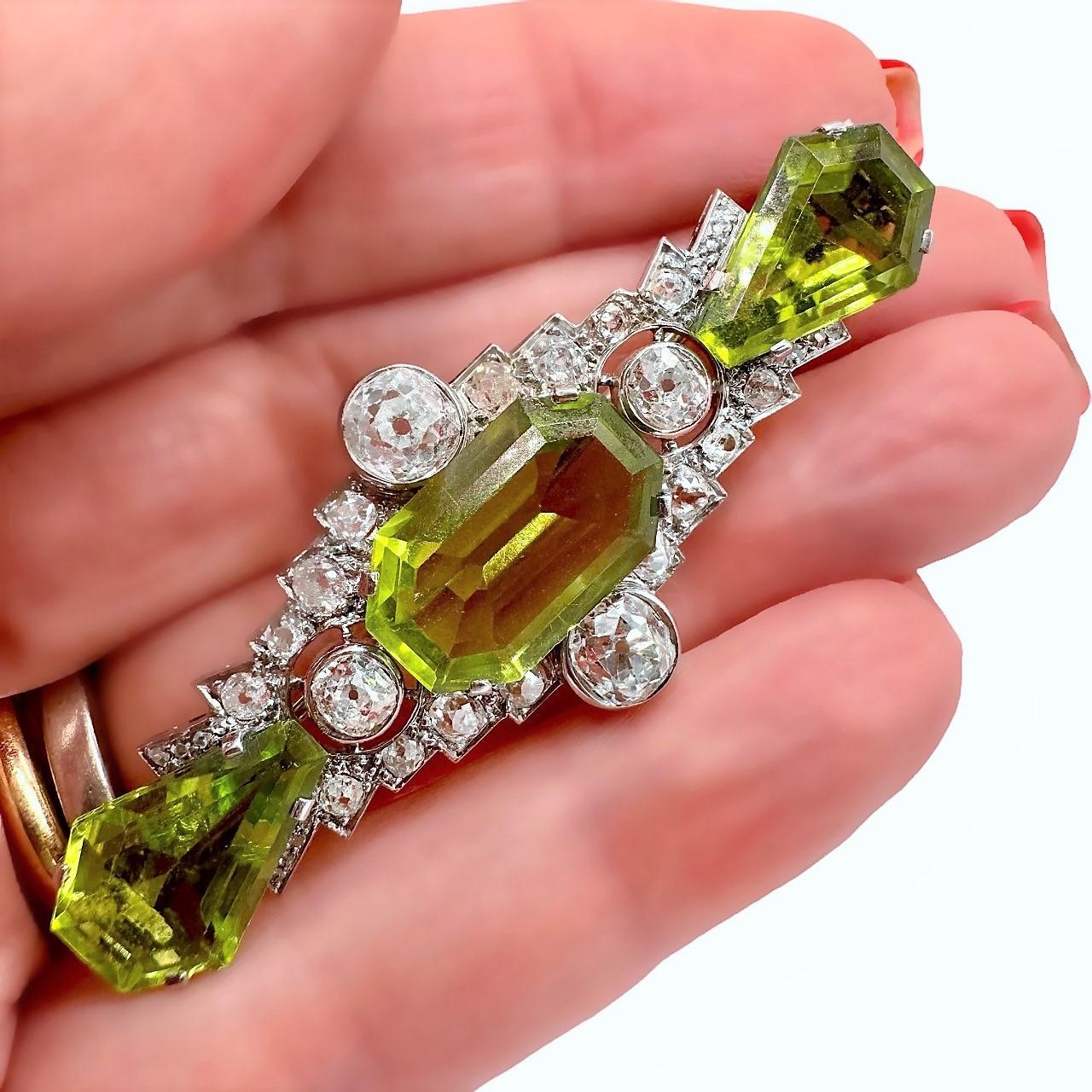 Women's or Men's Antique Art Deco Platinum Brooch with Diamonds and Peridot For Sale