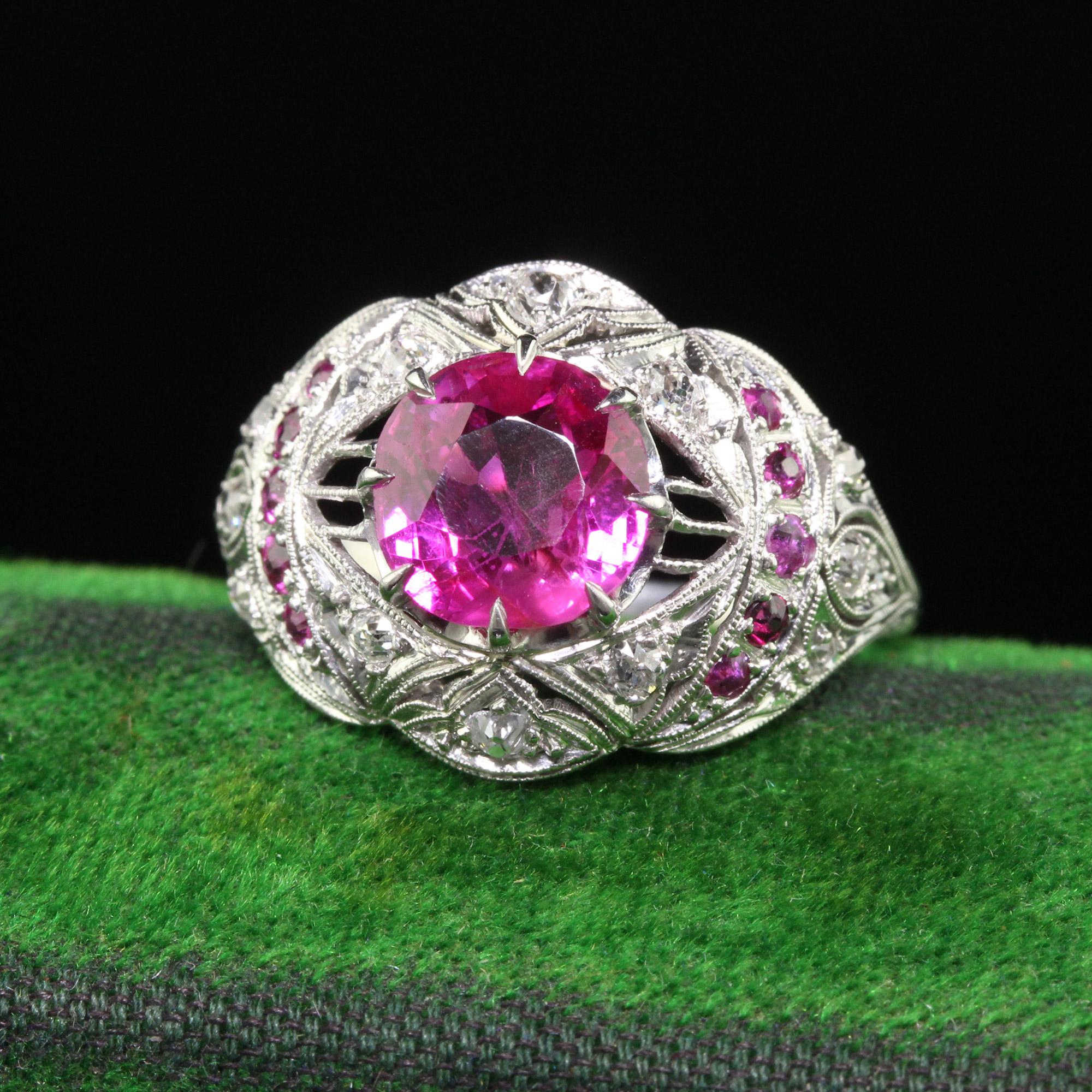Beautiful Antique Art Deco Platinum Burma Pink Sapphire and Diamond Filigree Engagement Ring - GIA. This gorgeous engagement ring is crafted in platinum. The center holds a natural pink sapphire with a GIA report. It is set in a beautiful Art Deco