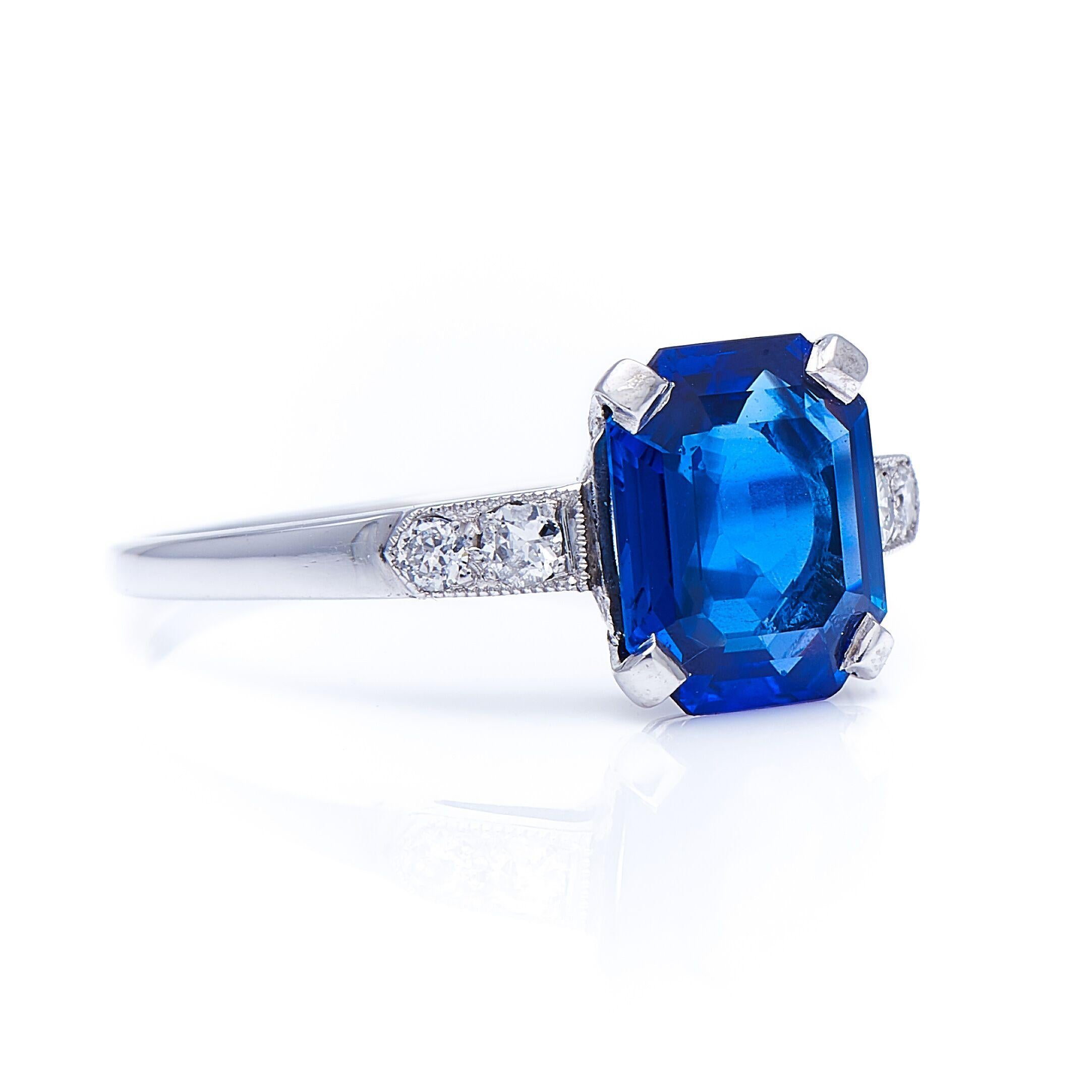 Sapphire and diamond ring, circa 1925. The striking shape of this untreated sapphire is known as an ‘emerald cut’. Originally developed specifically for emeralds due to their brittleness, the emerald cut, with its cut corners and low profile,