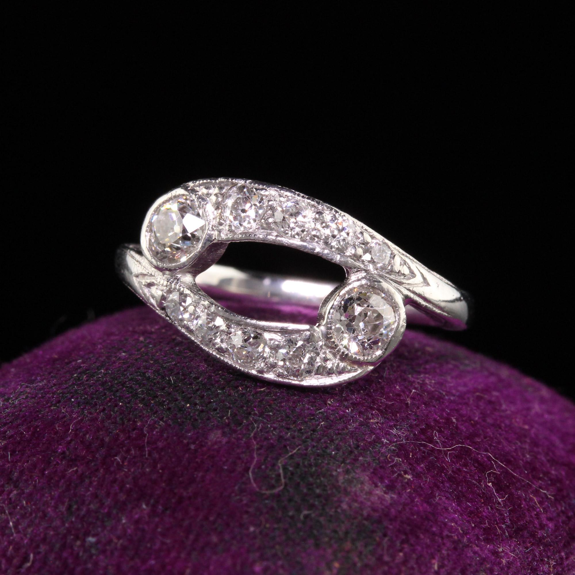 Beautiful Antique Art Deco Platinum Bypass Toi et Moi Old Euro Diamond Ring. This beautiful ring is crafted in platinum. The ring has a very interesting toi et moi / bypass design that has old european cut diamonds on it with fine engravings on the