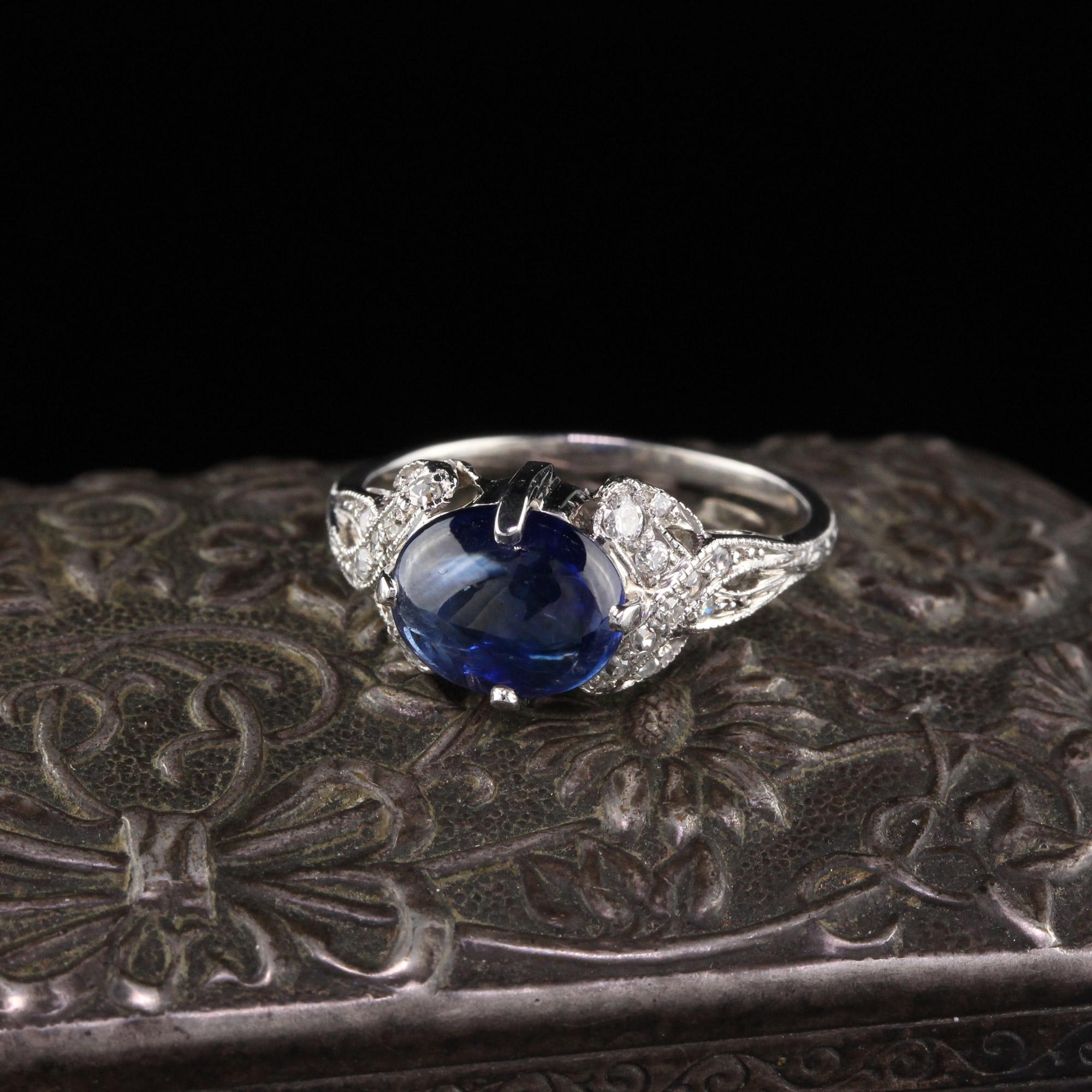 Beautiful Art Deco Platinum & Diamond Ring with an oval cabochon sapphire  set horizontally in the center. Small single cut diamonds create a beautiful design on either side of the sapphire center. In very good condition.

#R0306

Metal: