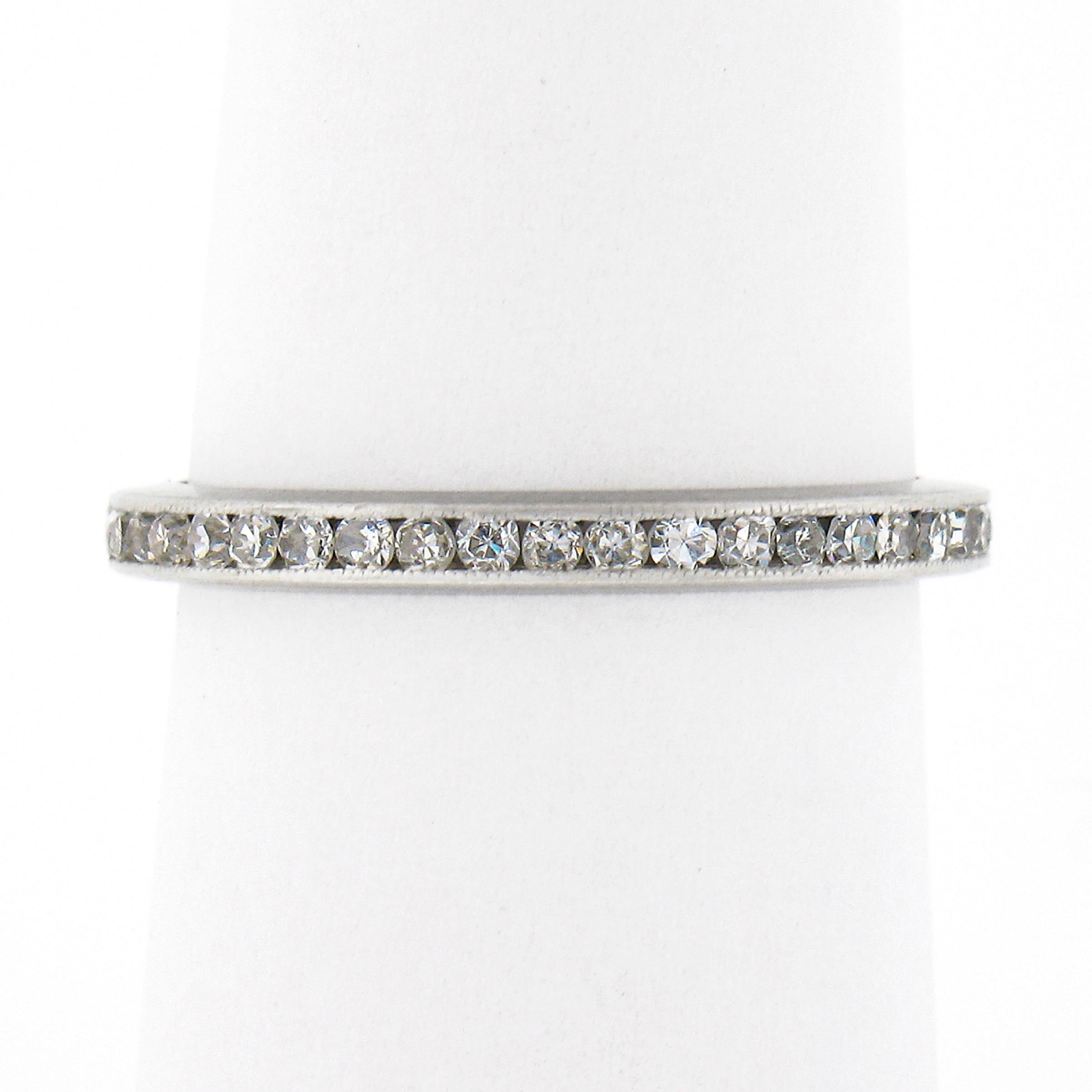 This gorgeous and well made antique diamond eternity band ring was crafted from solid .900 platinum during the art deco period. It features a simple design that carries very fine and super fiery old single cut diamonds that are neatly channel set