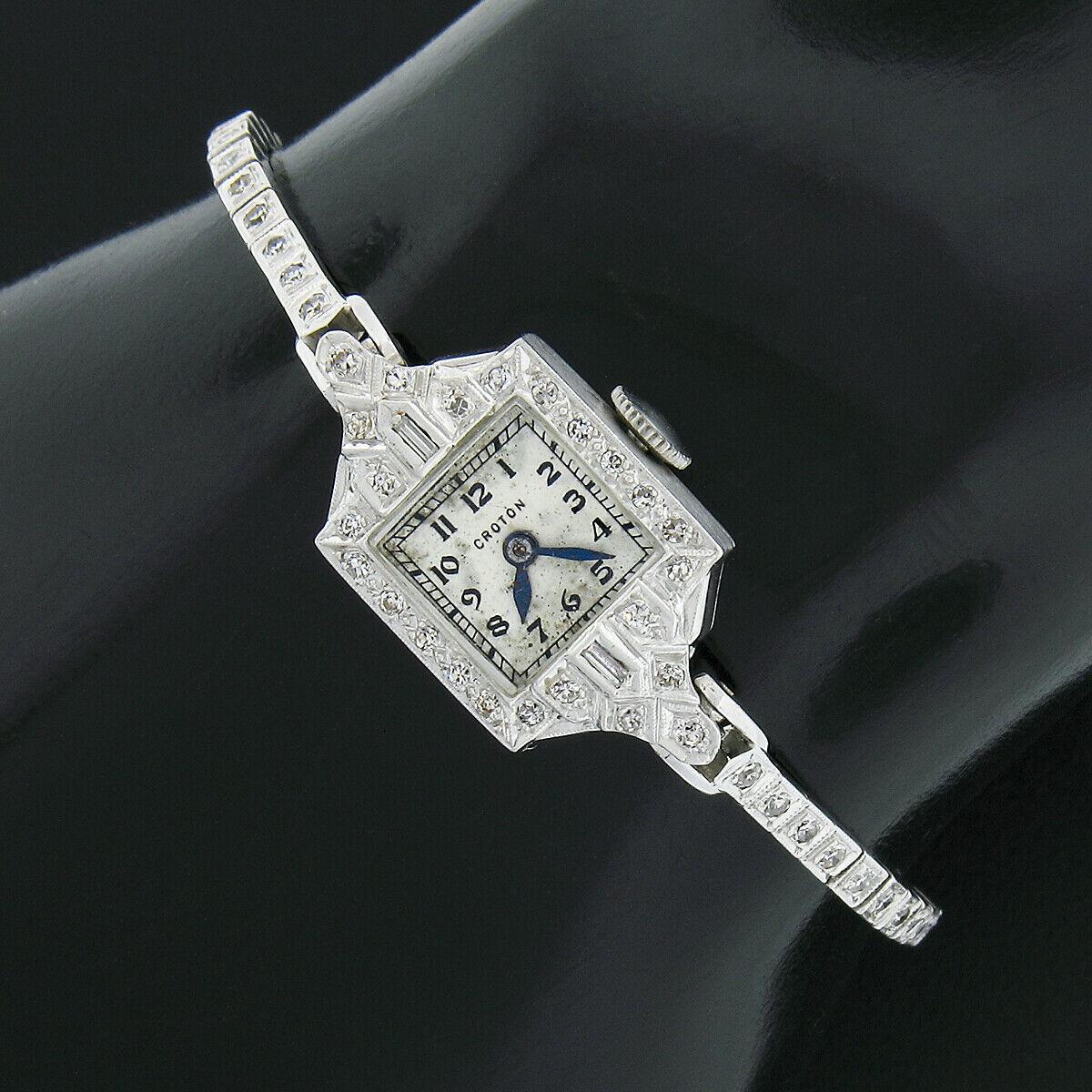 Here we have an antique ladies' wrist watch mounted in a solid platinum case and attached to a solid 14k white gold bracelet, both covered with approximately 0.69 carats of fine quality diamonds throughout. The bracelet features square milgrain