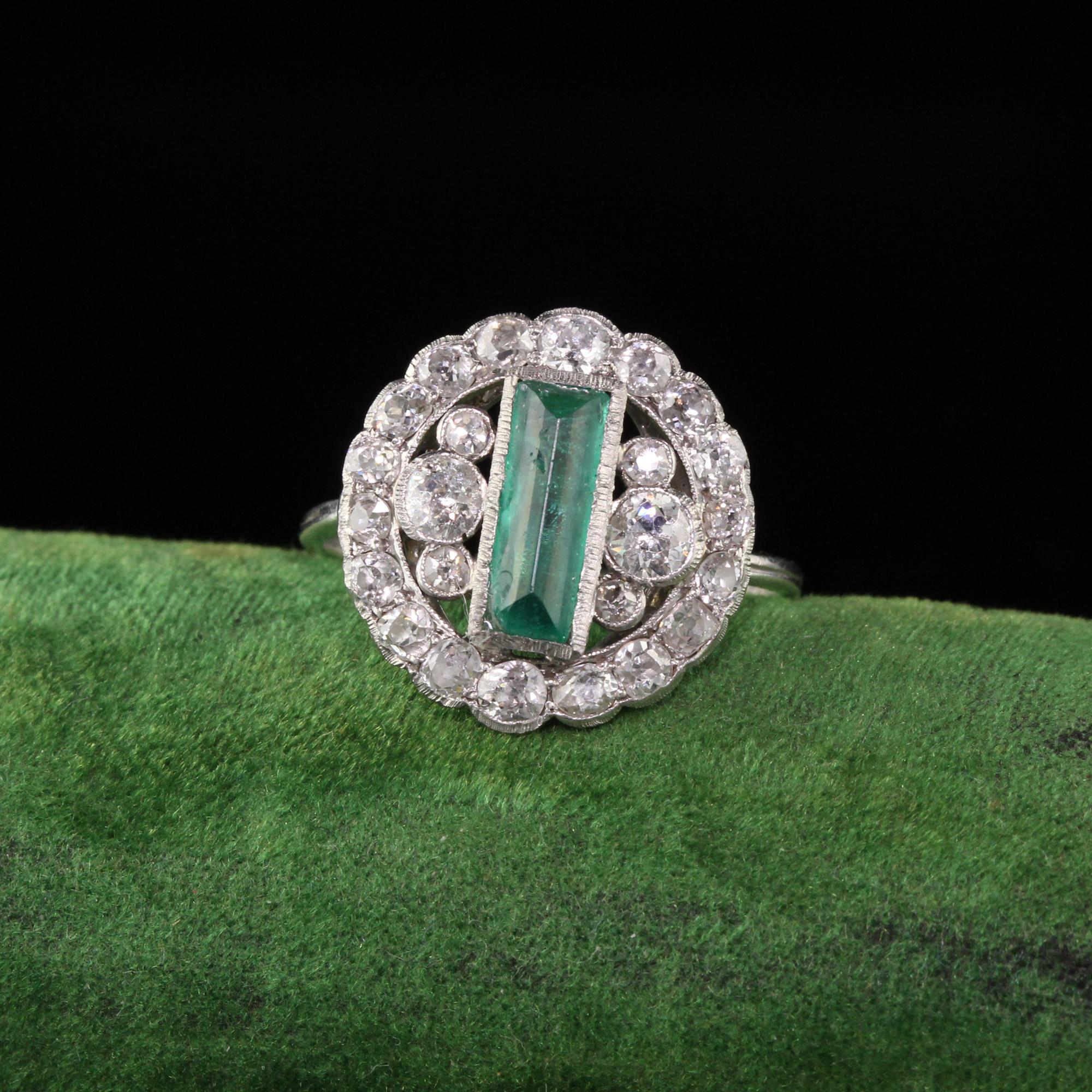 Gorgeous Art Deco diamond and emerald cocktail ring. One corner of the emerald is chipped. 

#R0430

Metal: Platinum

Weight: 4.7 Grams

Total Diamond Weight: Approximately 2.00 CTS

Diamond Color: H - I

Diamond Clarity: SI2

Emerald Measurement: