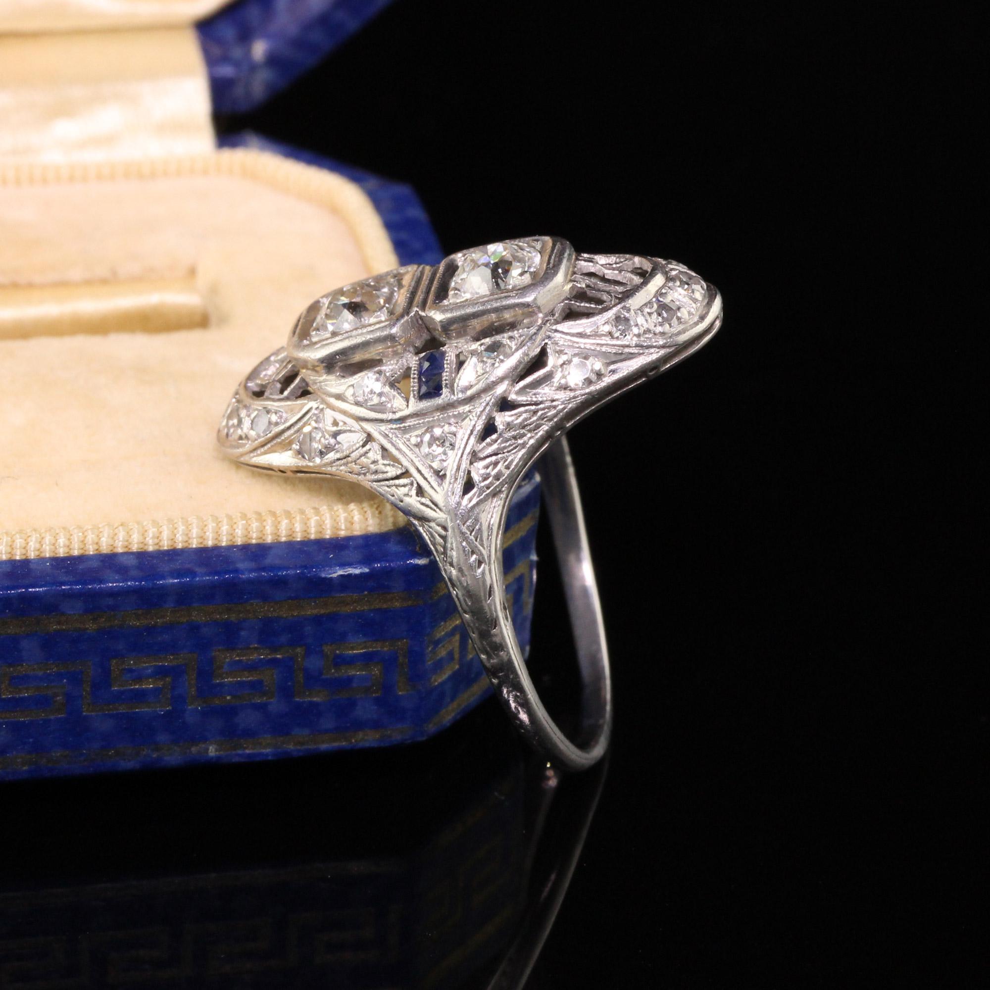 A gorgeous Antique Art Deco Platinum Diamond and Sapphire Filigree Shield Ring that features two beautiful old european cut diamonds set in a intricate platinum filigree mountings with sapphire accents.

Item #R0587

Metal: Platinum

Weight: 6.7