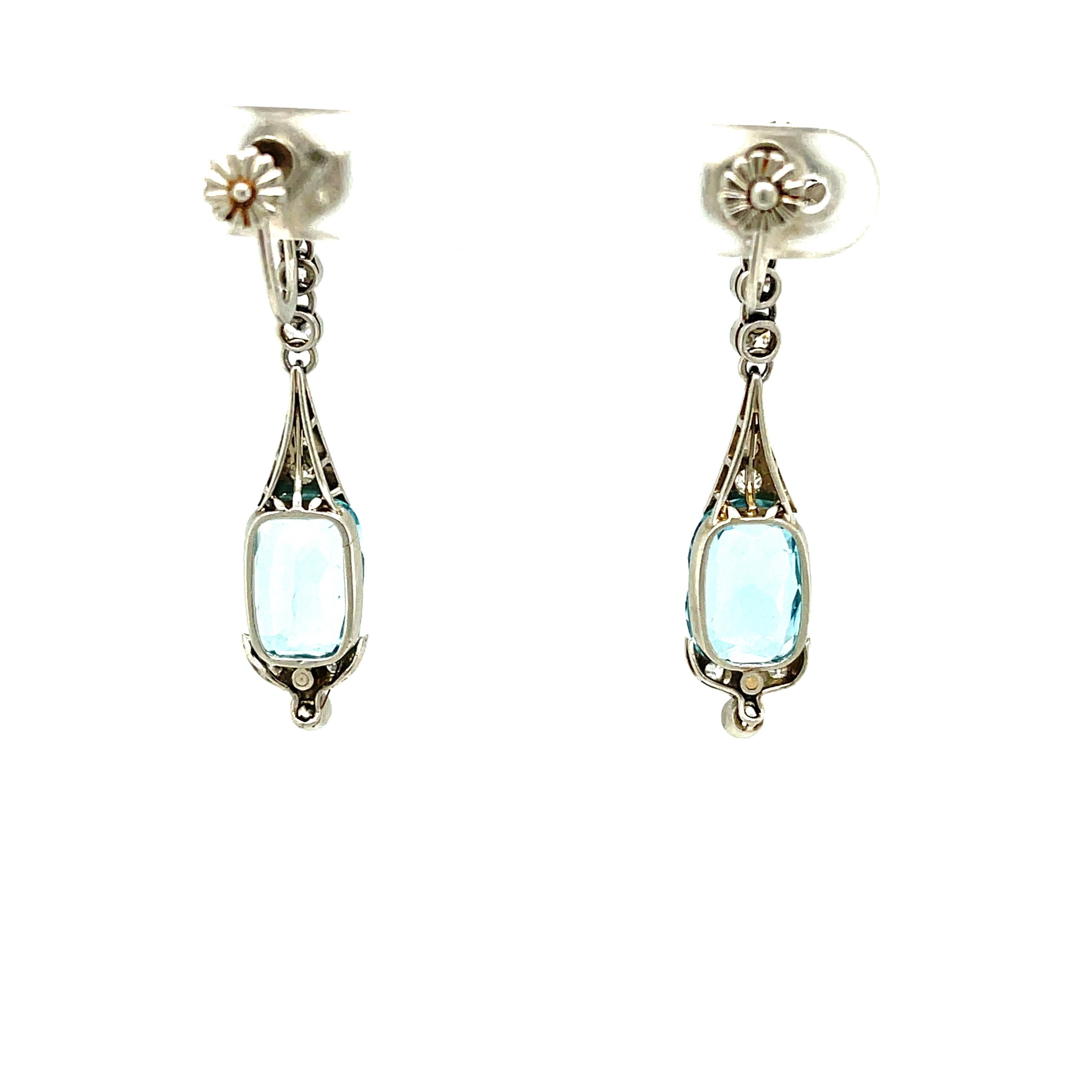 A rare pair of Art Deco platinum diamond aquamarine earrings, circa 1920. This pair of earrings is a lovely pendant earring suspending a faceted aquamarine. Such an earring is a rarity to find these days. The earrings are screw back, perhaps a later