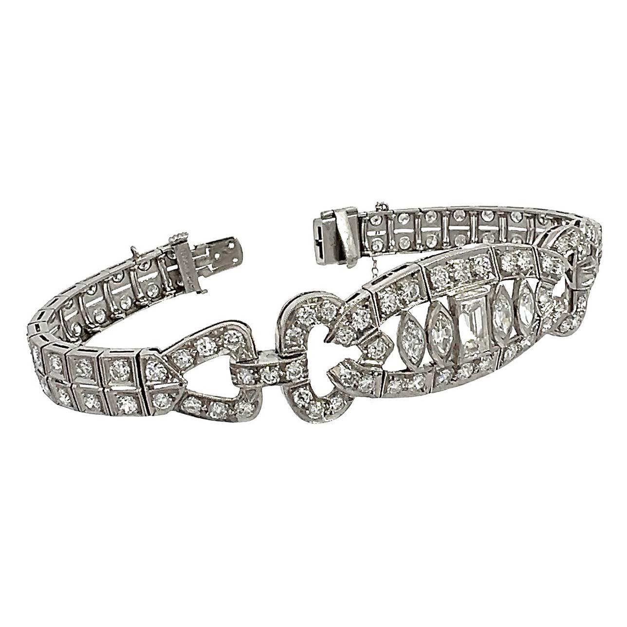 Antique Art Deco Diamond bracelet meticulously crafted with 4.5 to 5 carats of old European, baguette, and marquise-cut diamonds. The double-row diamond line bracelet has a wider central motif of marquise and baguette cut diamonds. The impressive