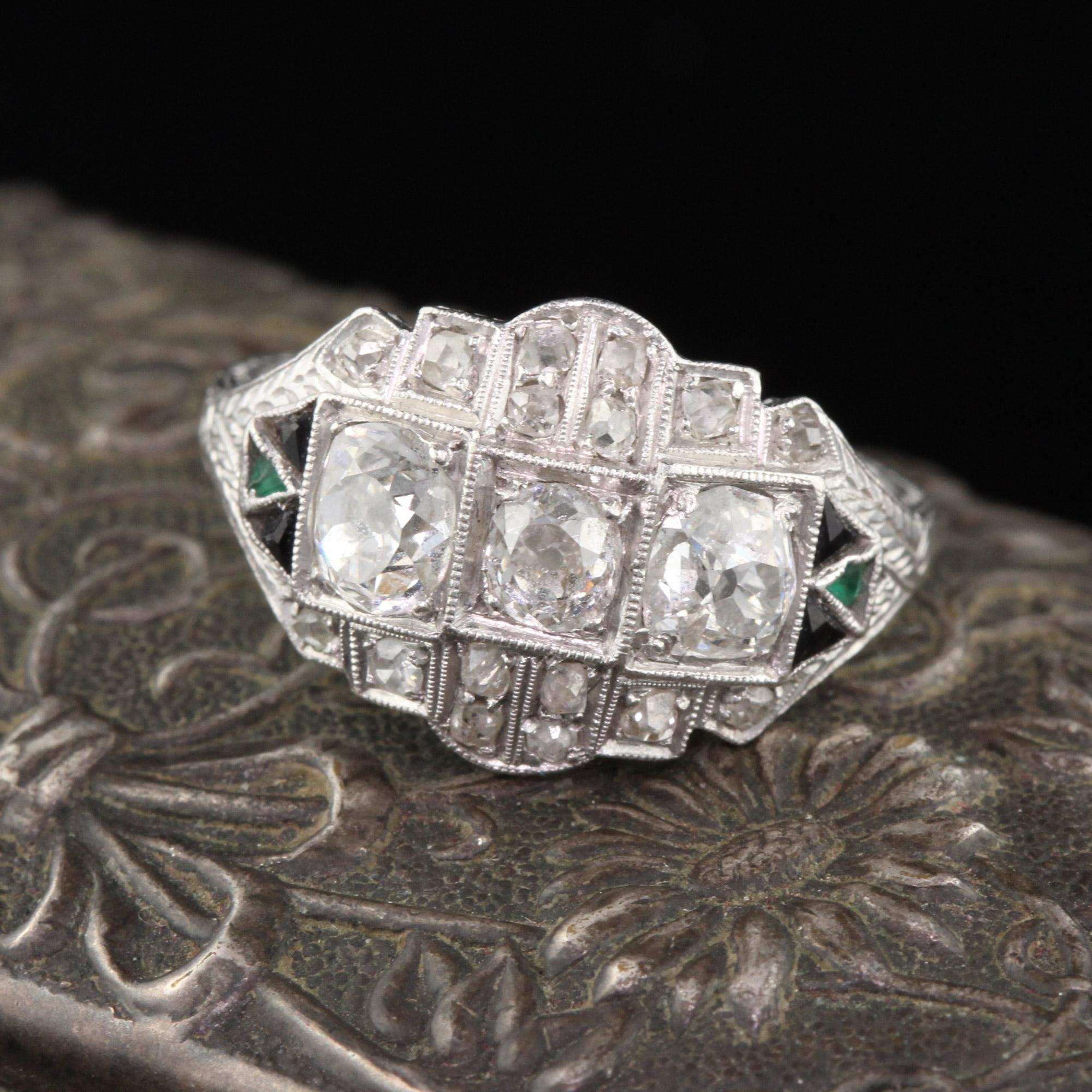 Antique Art Deco Platinum 3-stone ring with diamonds & triangular cut onyx and emeralds. 

#R0082

Metal: Platinum

Weight: 5 grams

Diamond Weight: Approximately 1 ctw

Diamond Color: I

Diamond Clarity: SI2

Ring Size: 7

This ring can be sized