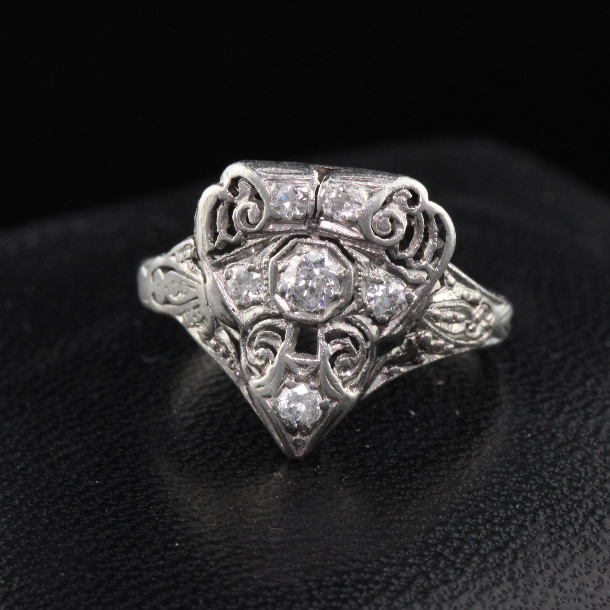 Antique Art Deco Platinum & Diamond Shield Shaped Ring With Filigree

#R0090

Metal: Platinum

Weight: 2.8 Grams

Total Diamond Weight: Approximately 0.15 cts

Diamond Color: H

Diamond Clarity: SI1

Ring Size: 4 (sizable)

This ring can be sized