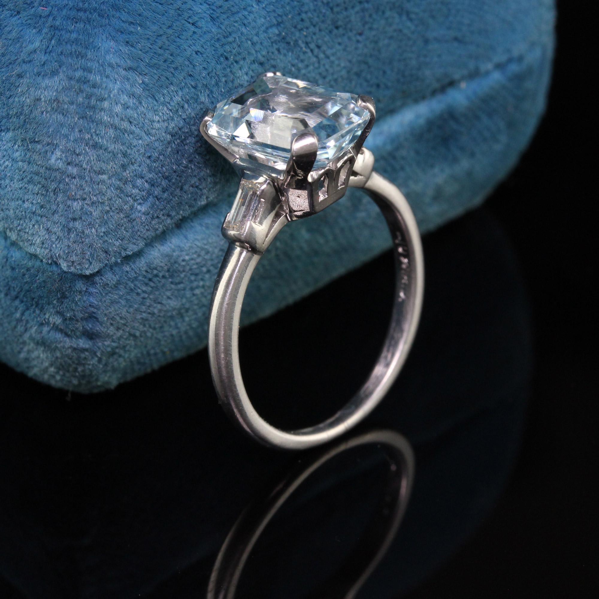 Gorgeous Antique Art Deco Platinum Emerald Cut Aquamarine Engagement Ring. This beautiful Art Deco engagement ring features an emerald cut aquamarine in the center in a platinum mounting flanked by two baguettes.

Item #R0812

Metal: