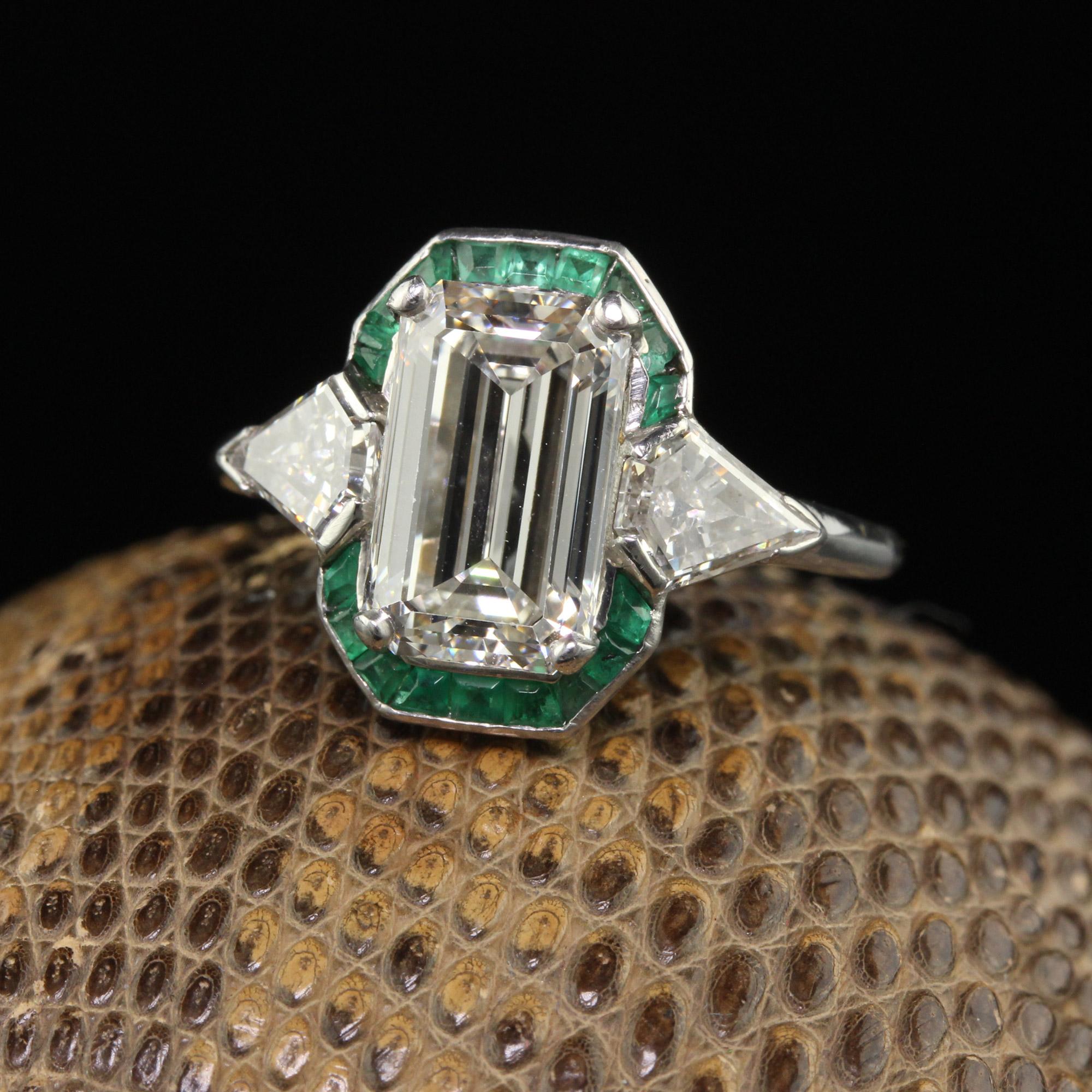 Beautiful Antique Art Deco Platinum Emerald Cut Diamond Emerald Halo Engagement Ring - GIA. This unbelievable engagement ring is crafted in platinum. The center holds an emerald cut diamond that has a GIA report. The proportions of this beautiful