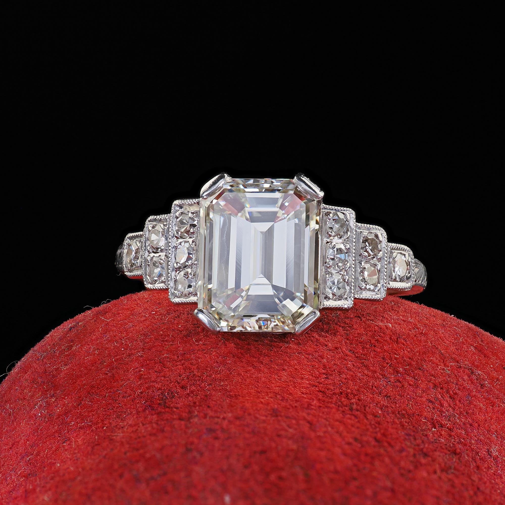 Beautiful Antique Art Deco Platinum Emerald Cut Diamond Engraved Engagement Ring - GIA. This gorgeous Art Deco emerald cut diamond engagement ring is crafted in platinum. This beautiful ring features a large emerald cut diamond in the center of a