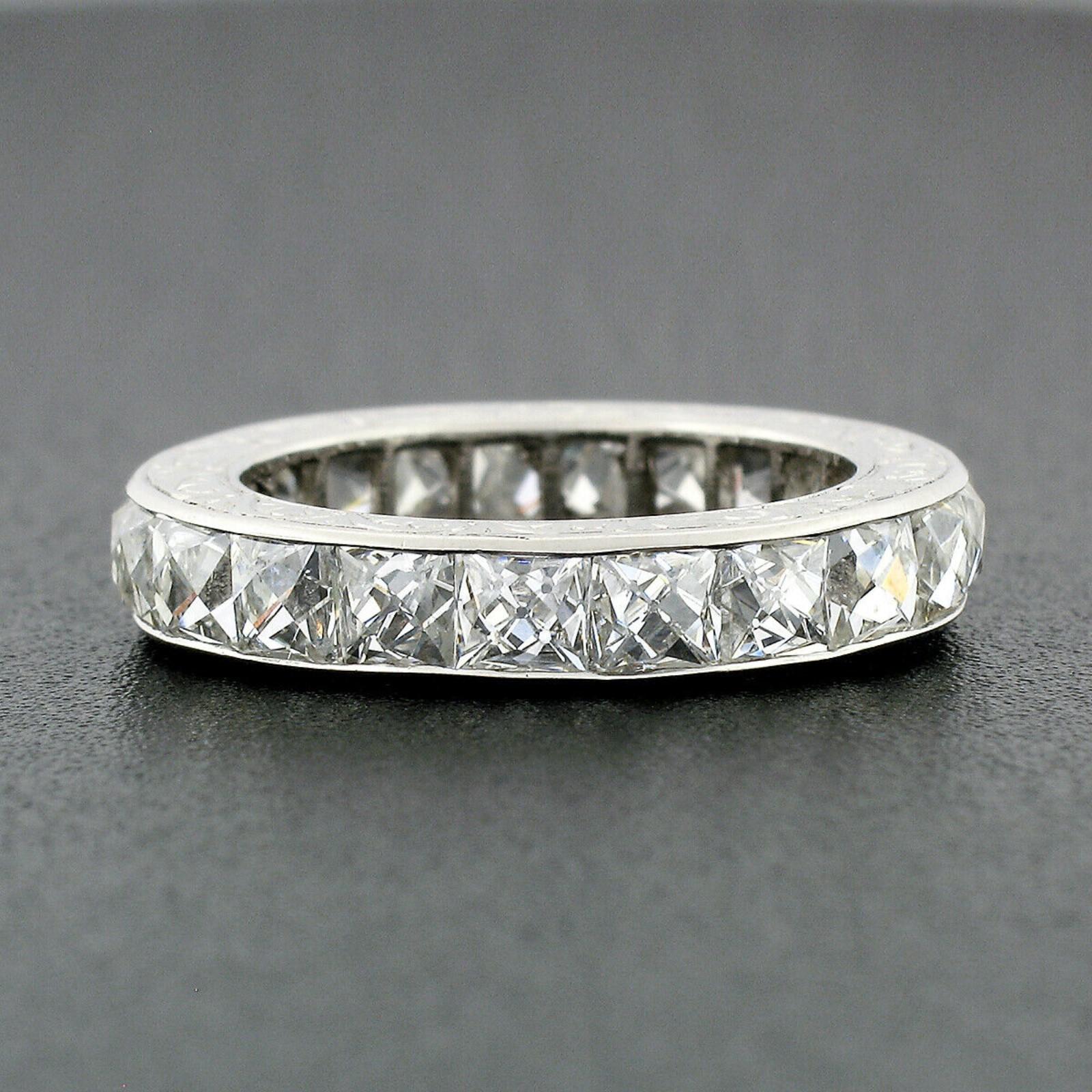 This absolutely stunning antique diamond eternity band ring was crafted from solid .900 platinum during the art deco period. It features a simple channel setting that carries 20 old French cut diamonds with open culet all the way around the band.