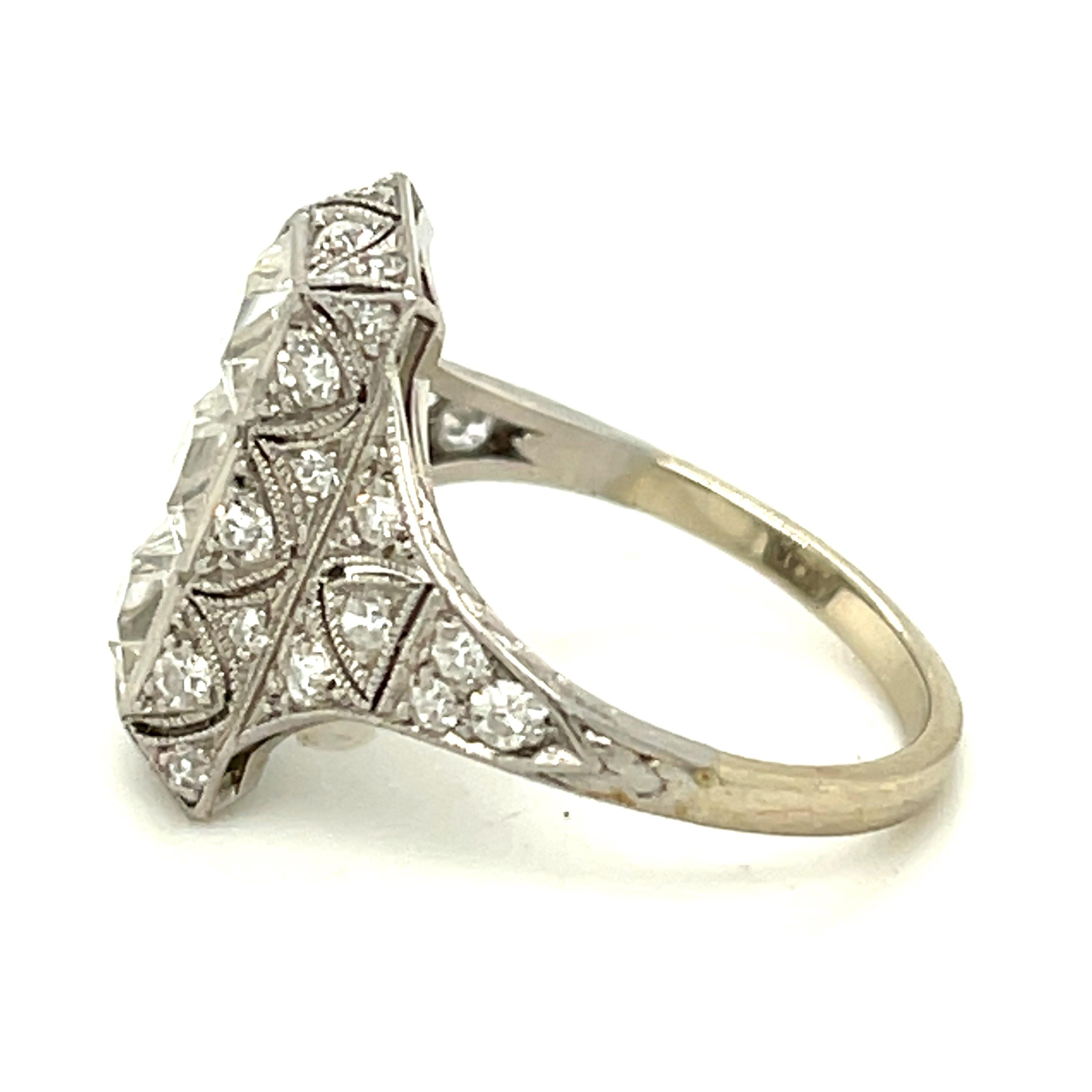 Antique Art Deco filigree platinum diamond ring centering upon three French Cut diamonds, circa 1920. The three white and clean diamonds weigh approximately 0.75 carats each. The mounting has  28 single cut diamonds weighing an additional 0.70