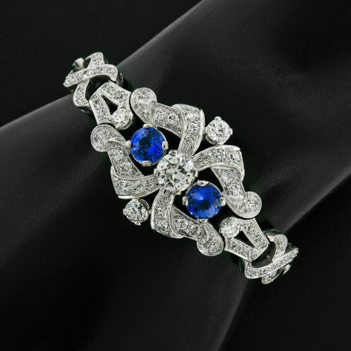 Here we have an absolutely stunning art deco period bracelet, which was crafted from solid .900 platinum, featuring a GIA certified old European cut diamond at its center flanked by a pair of natural royal blue sapphires. The center diamond weighs